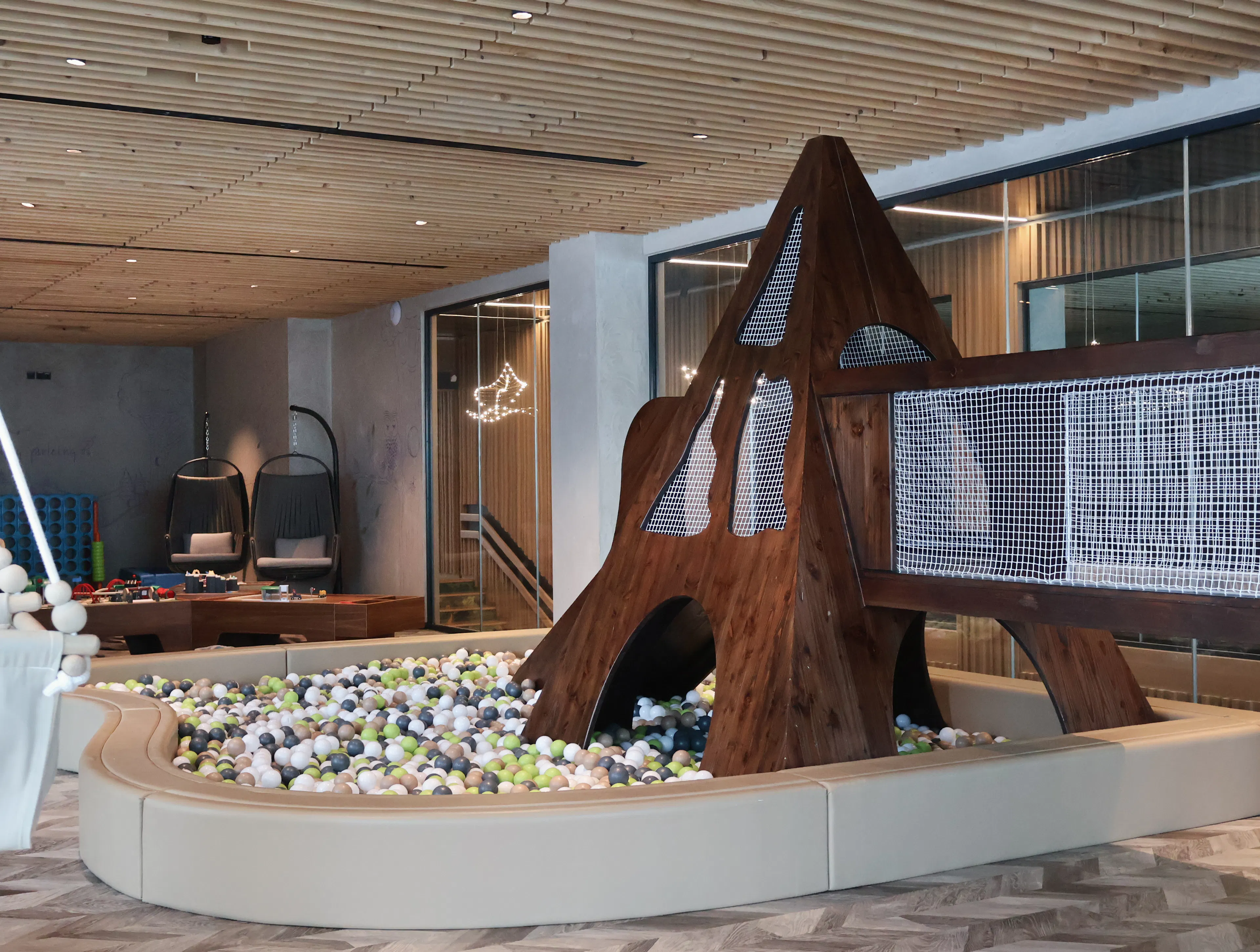 Family play area with ball pit and climbing tower at The Grand Green – Familux Resort.