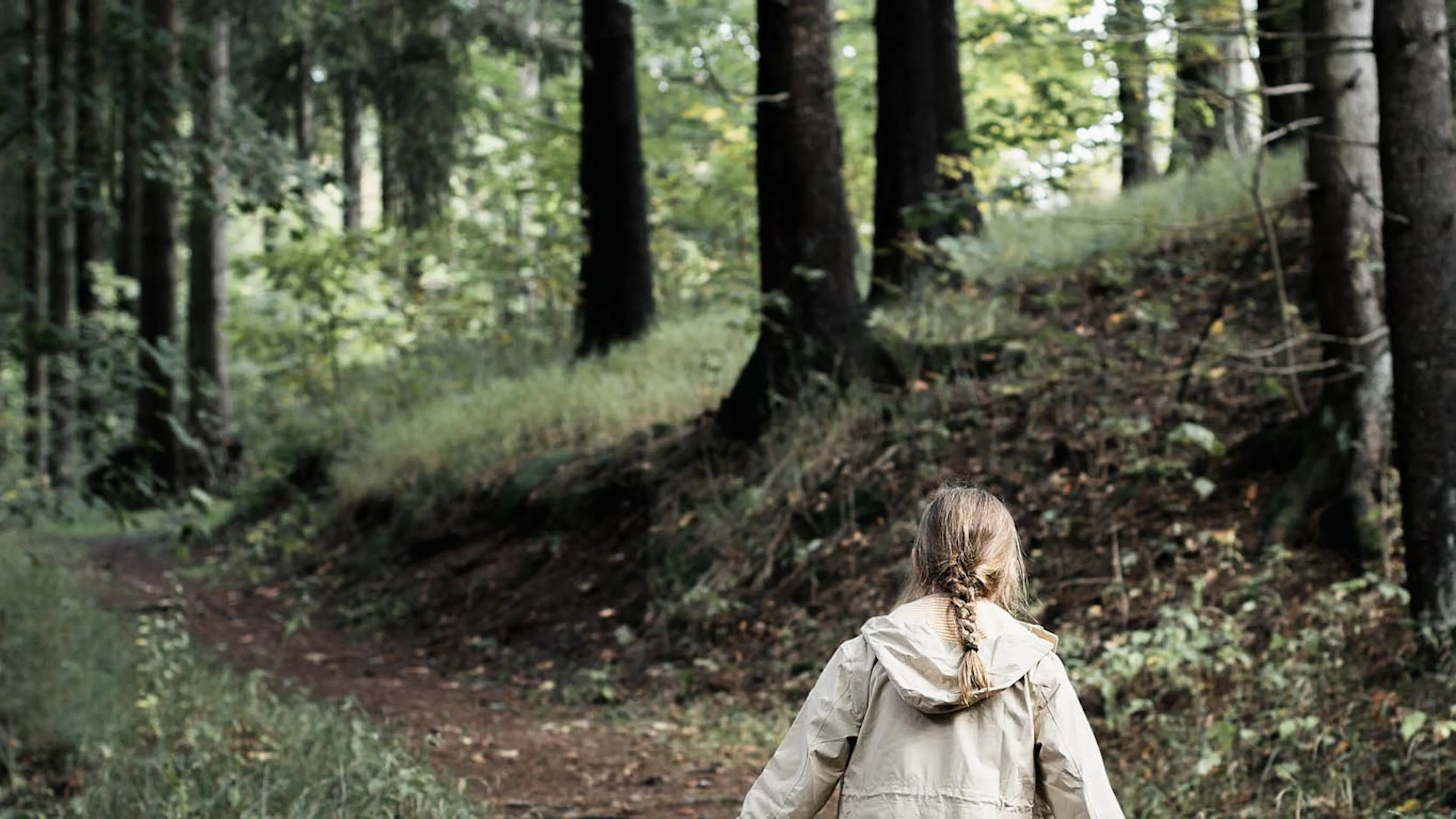 Girl walking in the forest in autumn.
