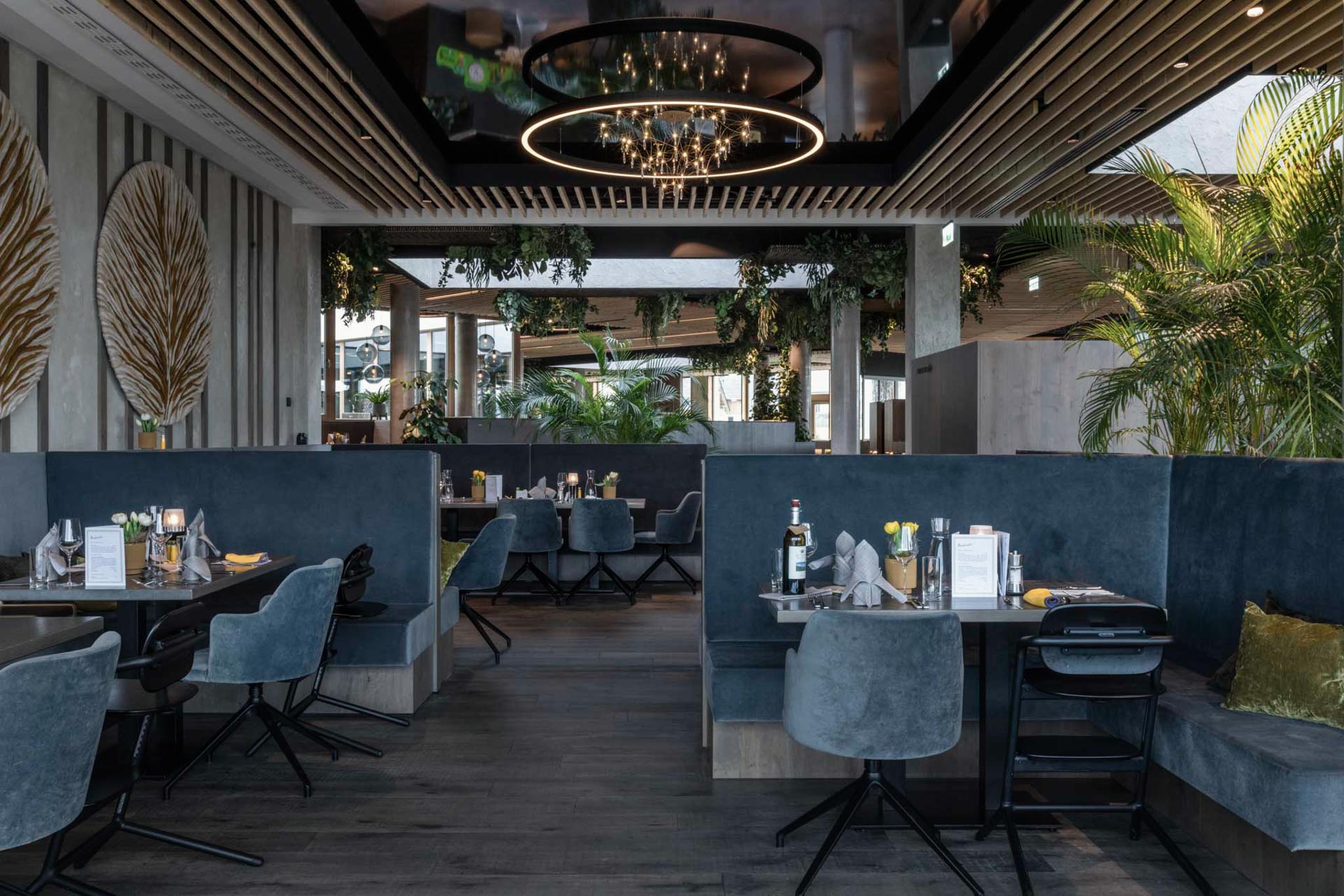 Restaurant with chairs and tables at The Grand Green – Familux Resort.