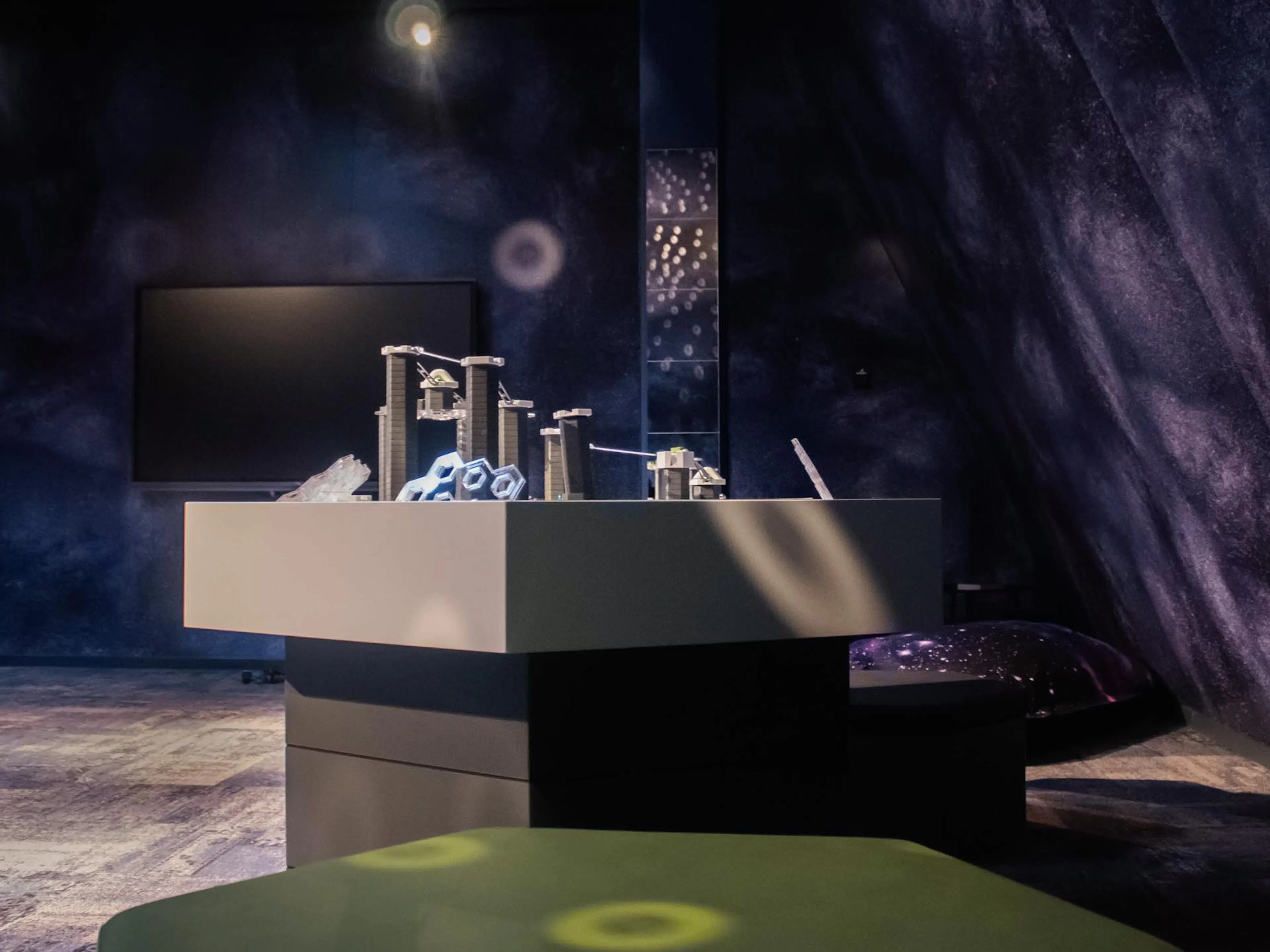 Space-themed teen club with games table at The Grand Green – Familux Resort.