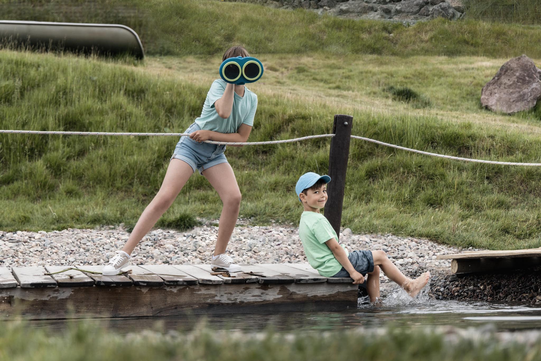 Girl and boy playing on the raft on the playground at The Grand Green – Familux Resort.