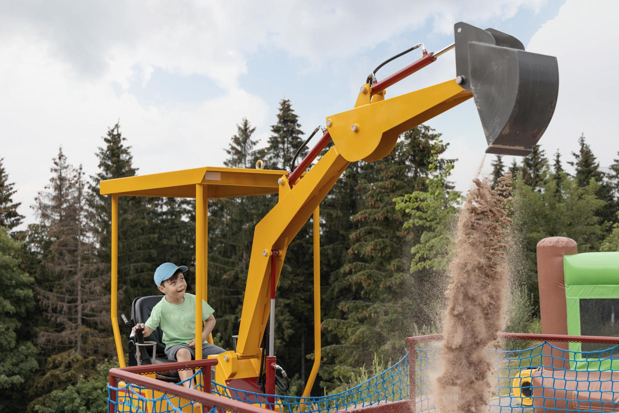 Girl and boy playing on the raft on the playground at The Grand Green – Familux Resort.