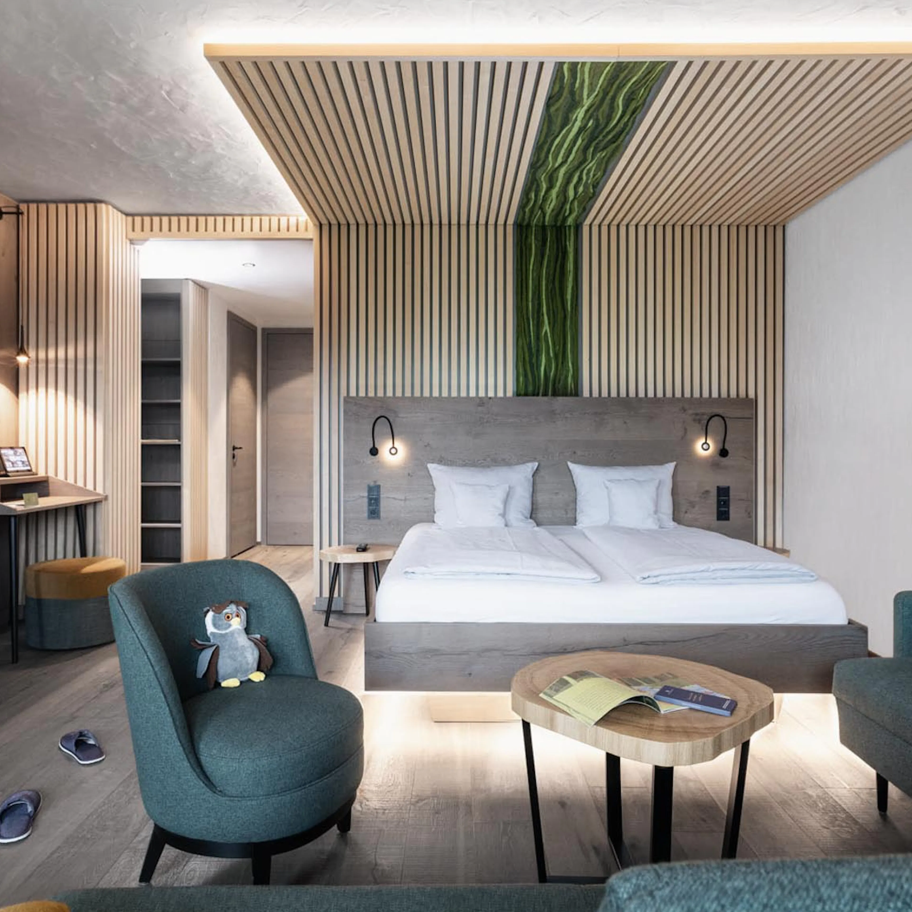 Family suite with bed and seating area at The Grand Green – Familux Resort.