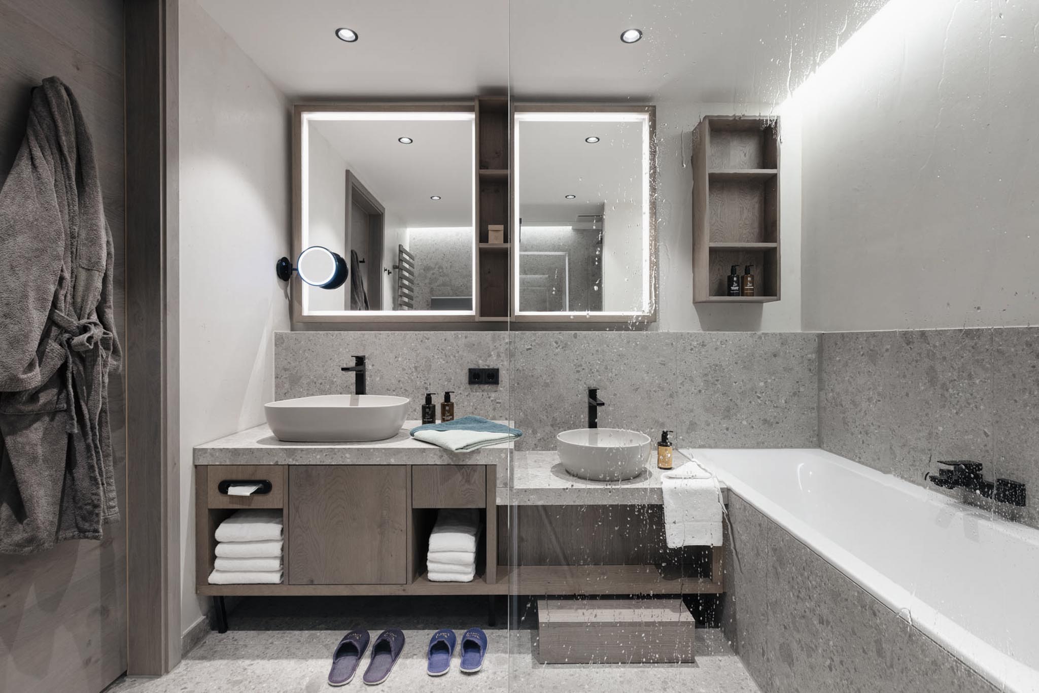 Bathroom with towels and bath at The Grand Green – Familux Resort.