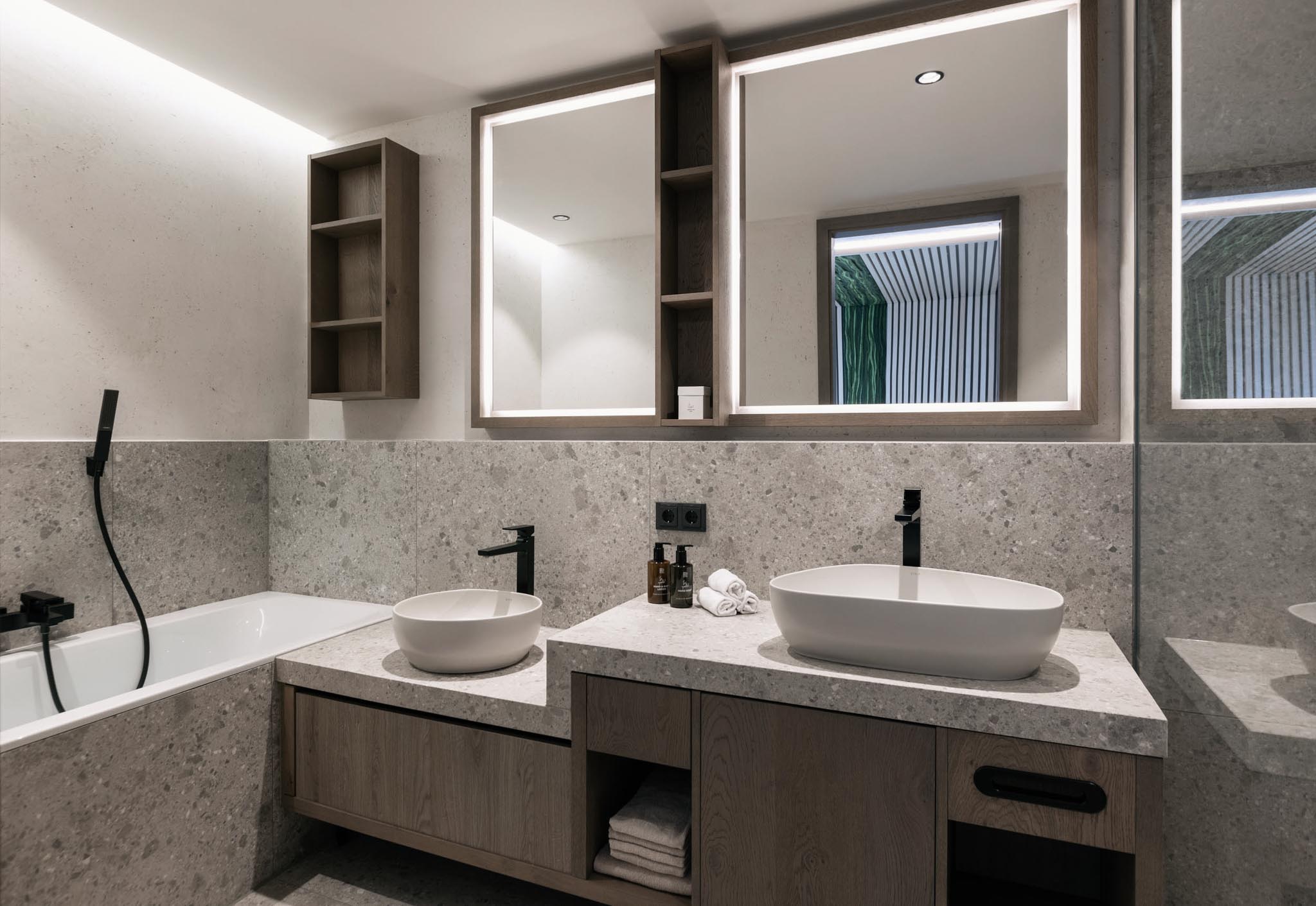 Bathroom with bath and washbasin in a suite at The Grand Green – Familux Resort.