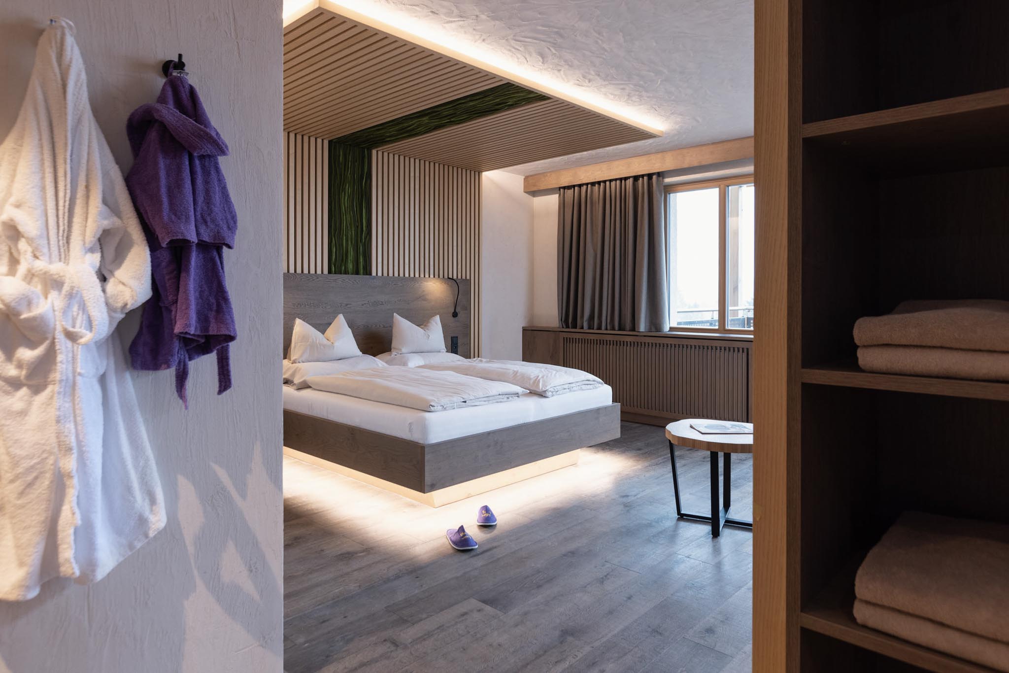 Family suite with bed and bathrobes at The Grand Green – Familux Resort.