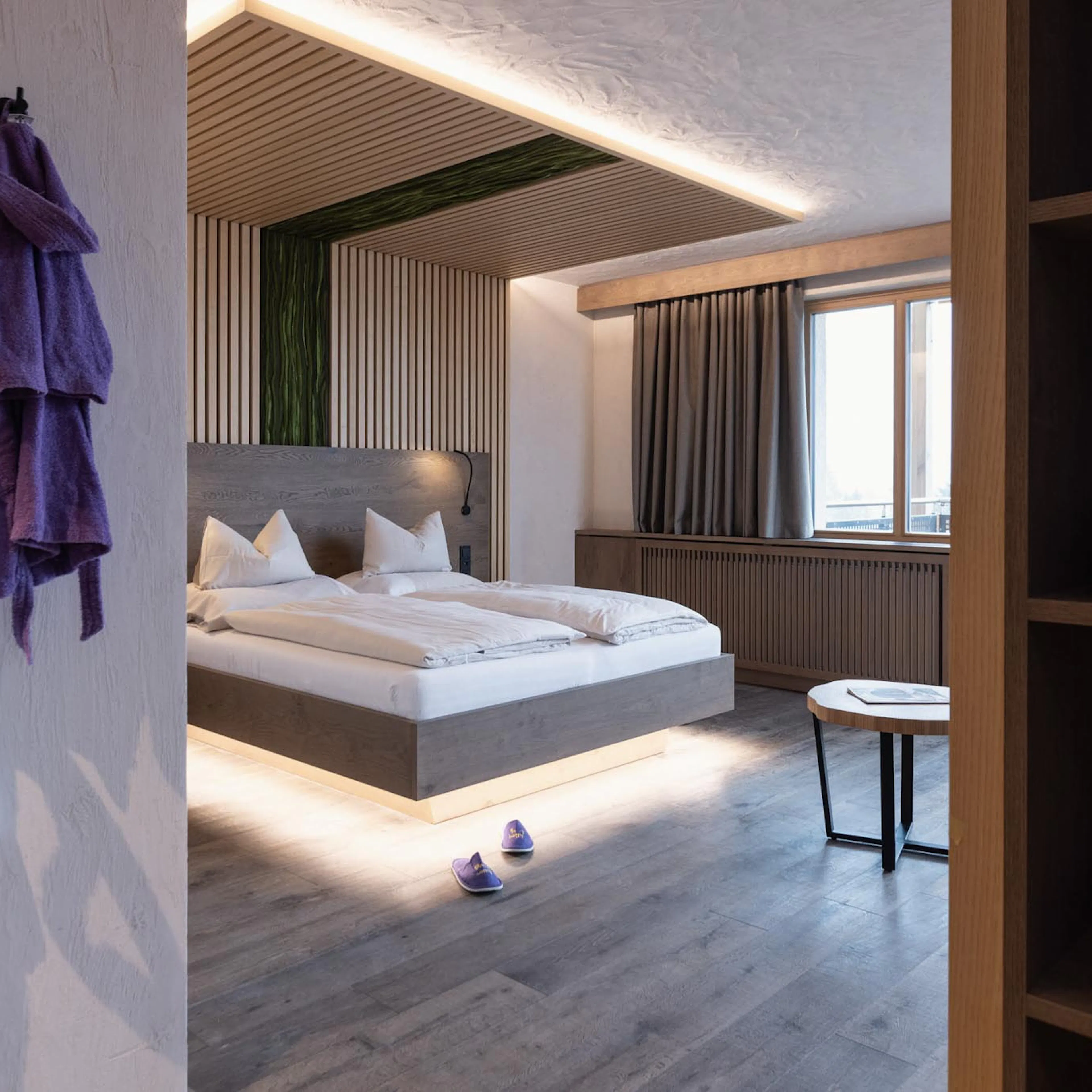 Family suite with bed and bathrobes at The Grand Green – Familux Resort.