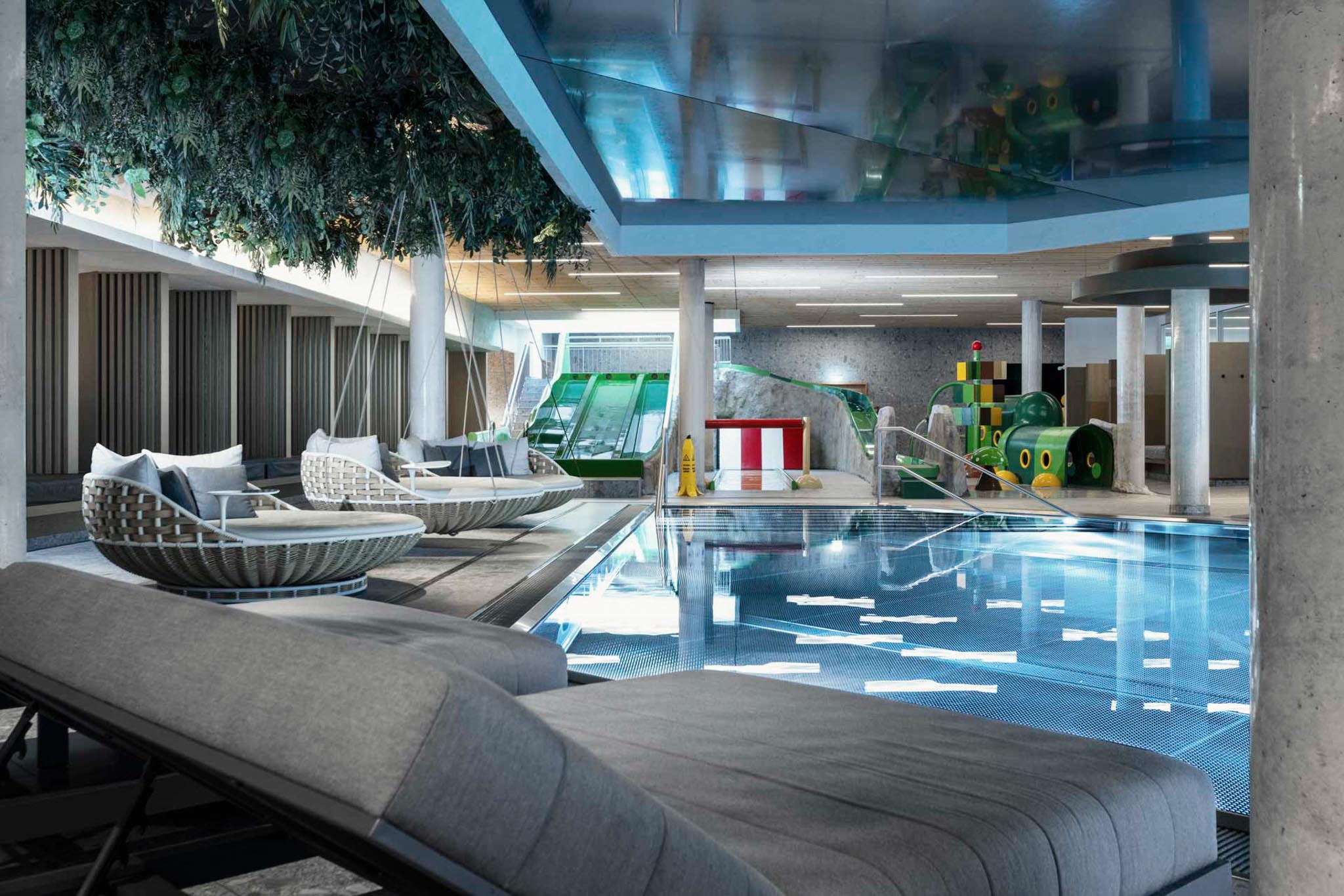Pool with slides and sun loungers at The Grand Green – Familux Resort.