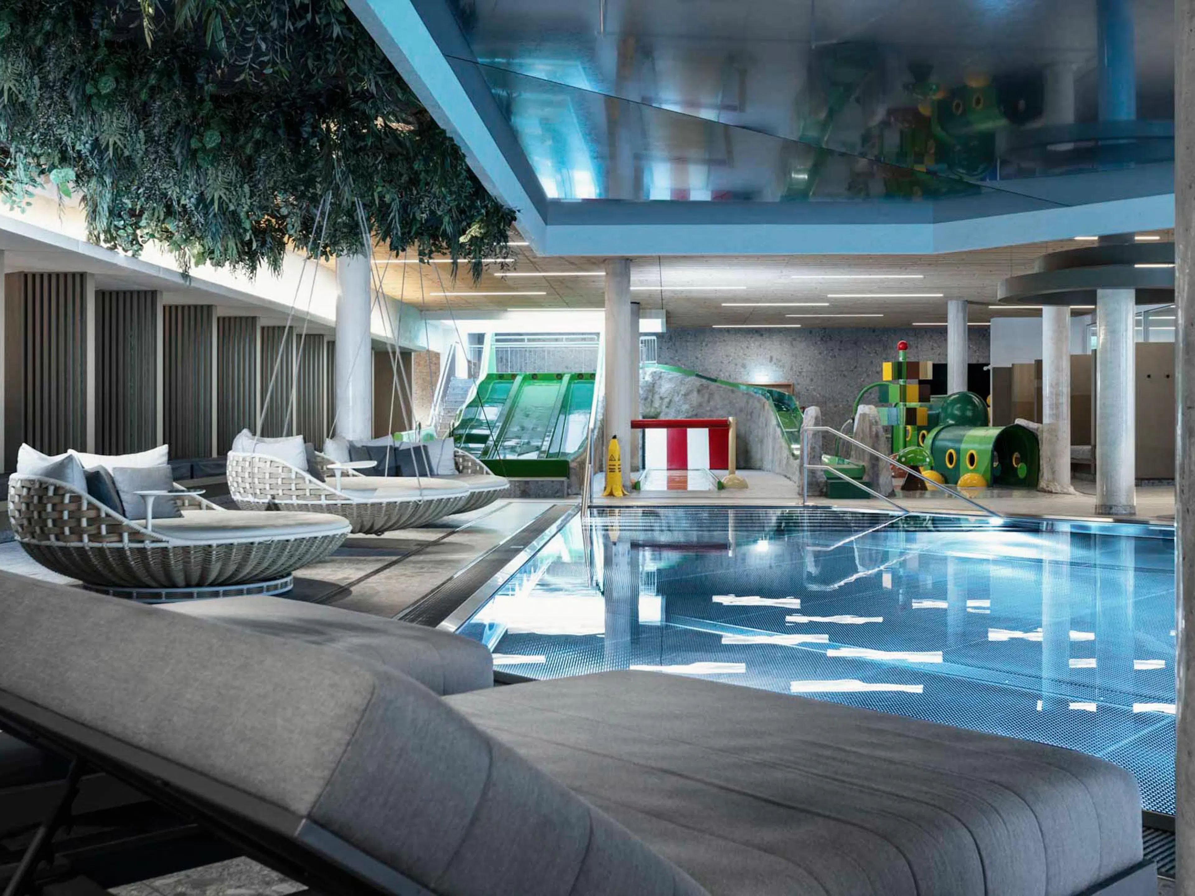 Pool with slides and sun loungers at The Grand Green – Familux Resort.