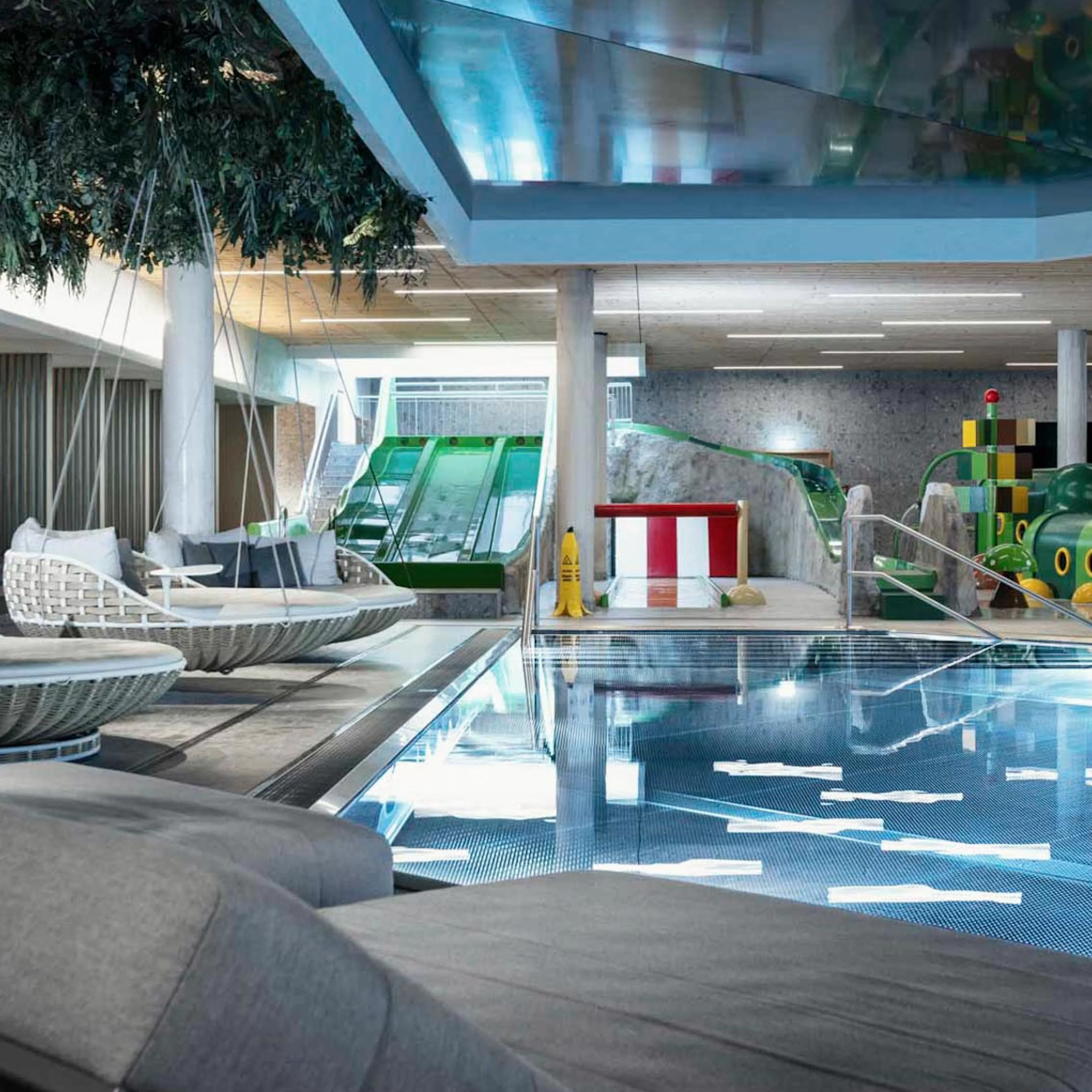 Pool with slides and sun loungers at The Grand Green – Familux Resort.