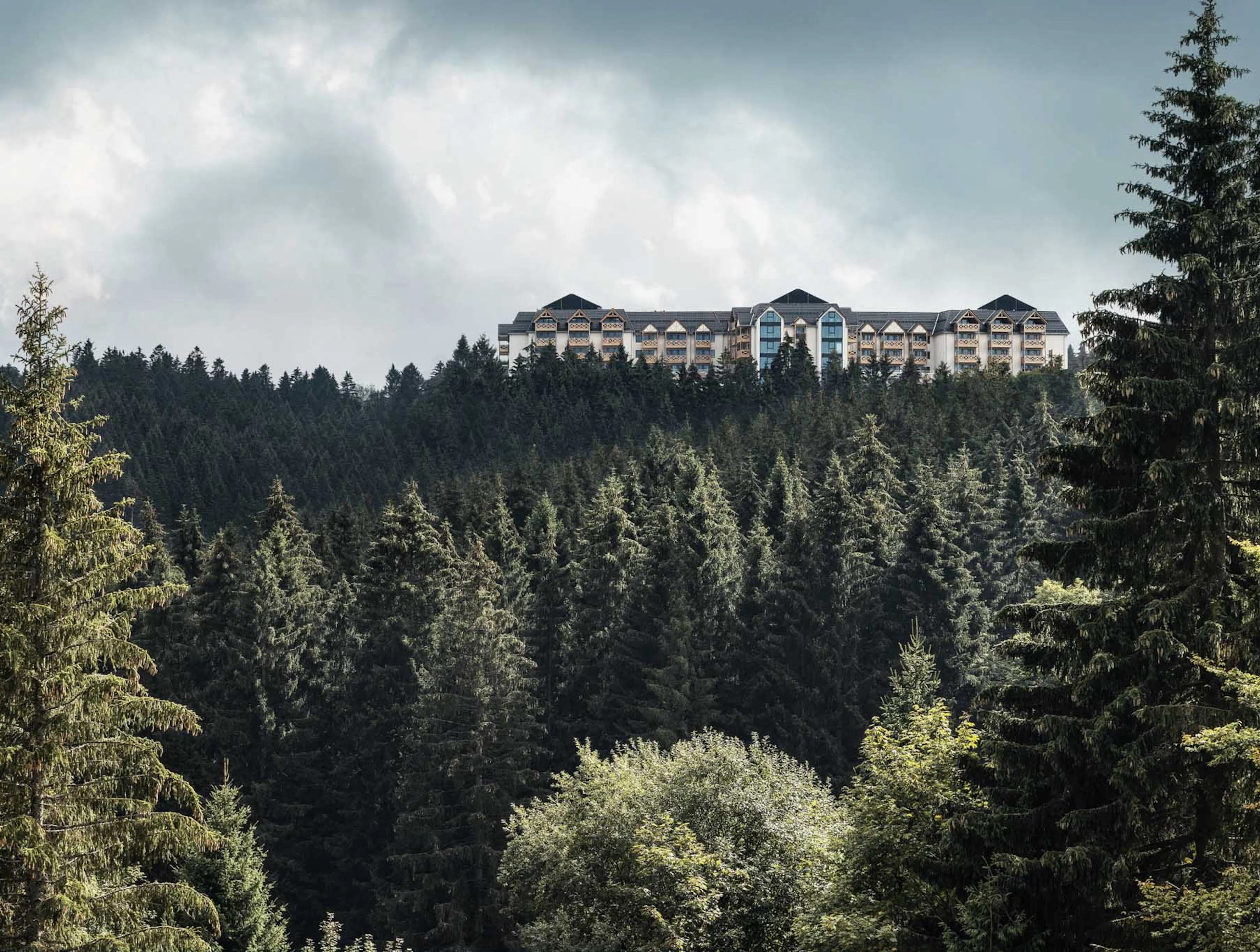 Aerial drone shot of The Grand Green – Familux Resort with the Thuringian Forest.