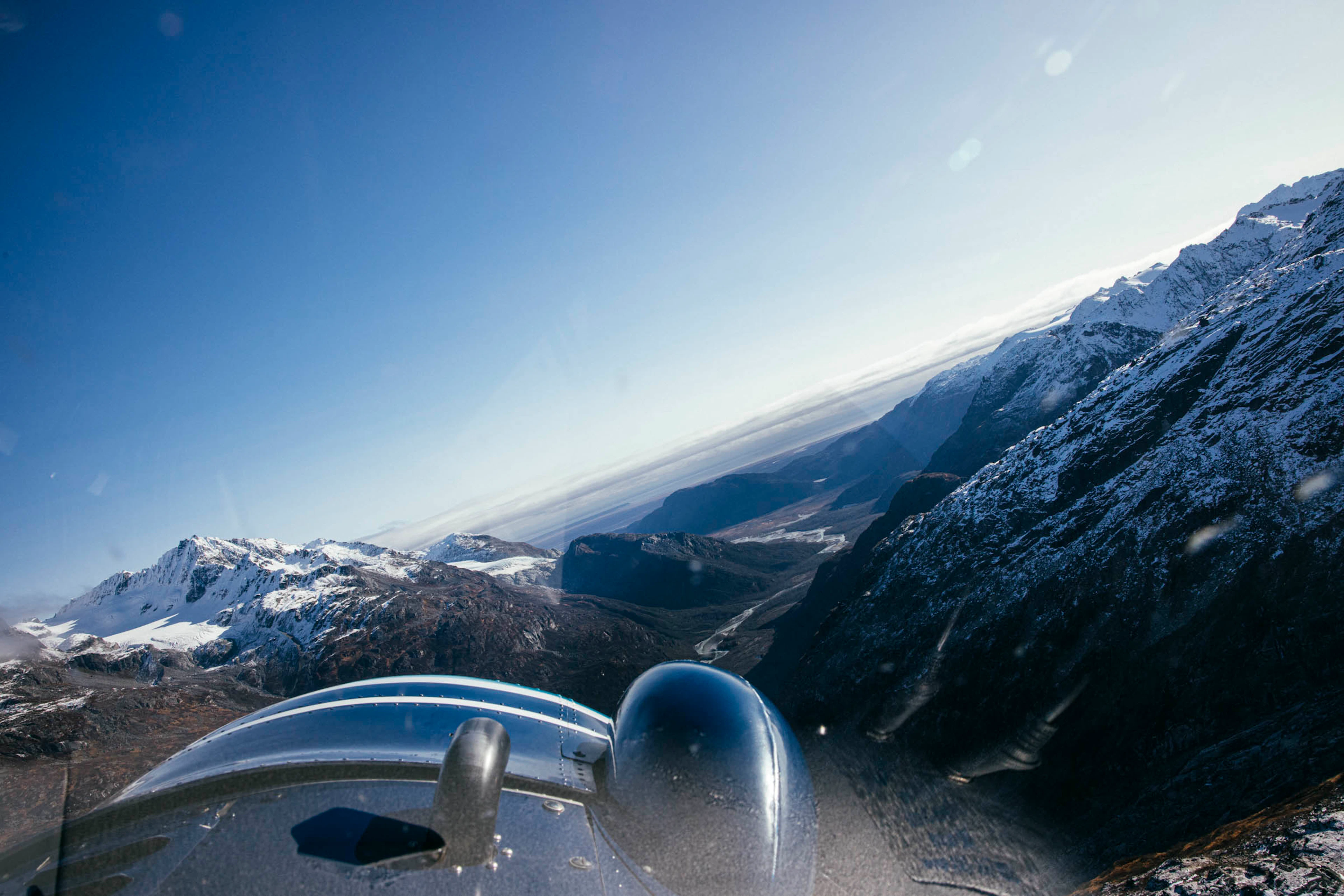 Bush plane flying over Alaska mountains en route to Bristol Bay fishing trip