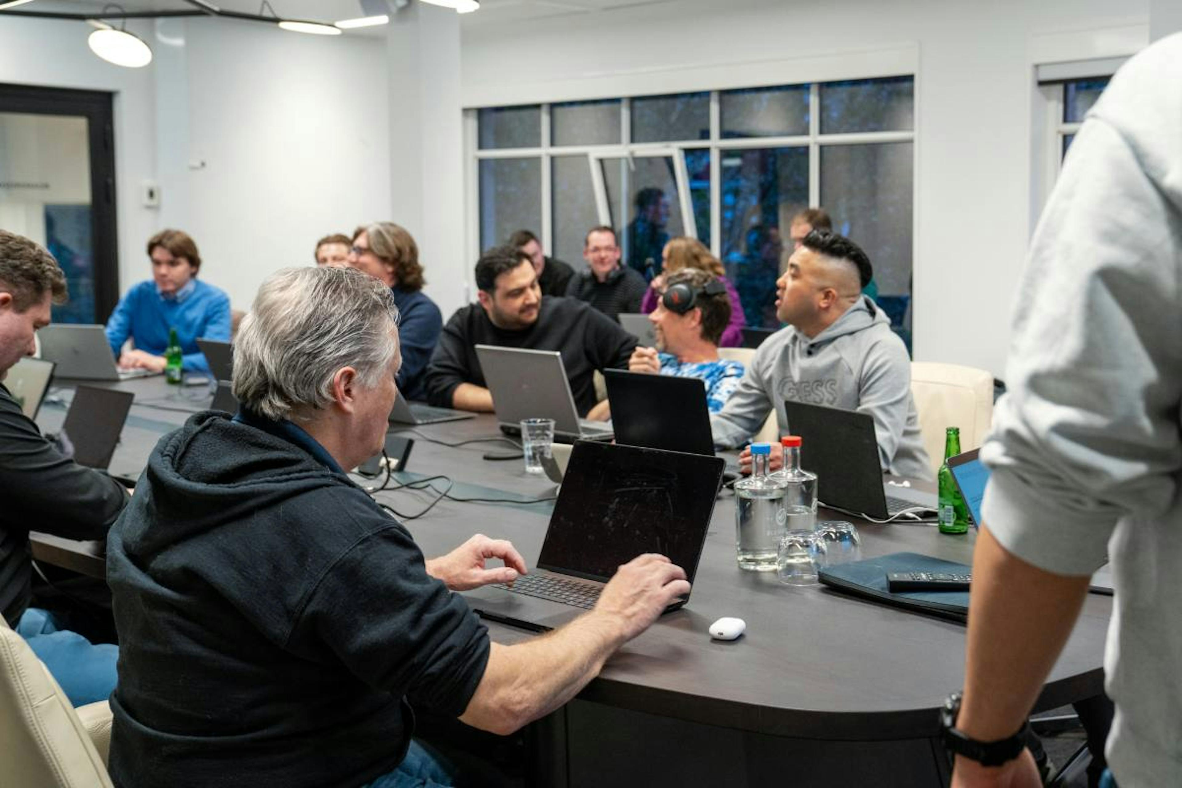 Een groep it developers zitten aan een tafel tijdens de creative coding sessie van de Masterminds Day van The.NextGen