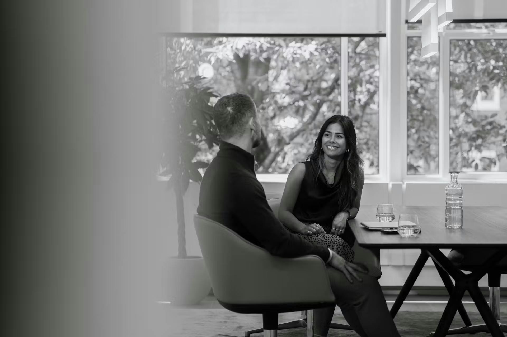 Zwart wit afbeelding van werknemers in gesprek.