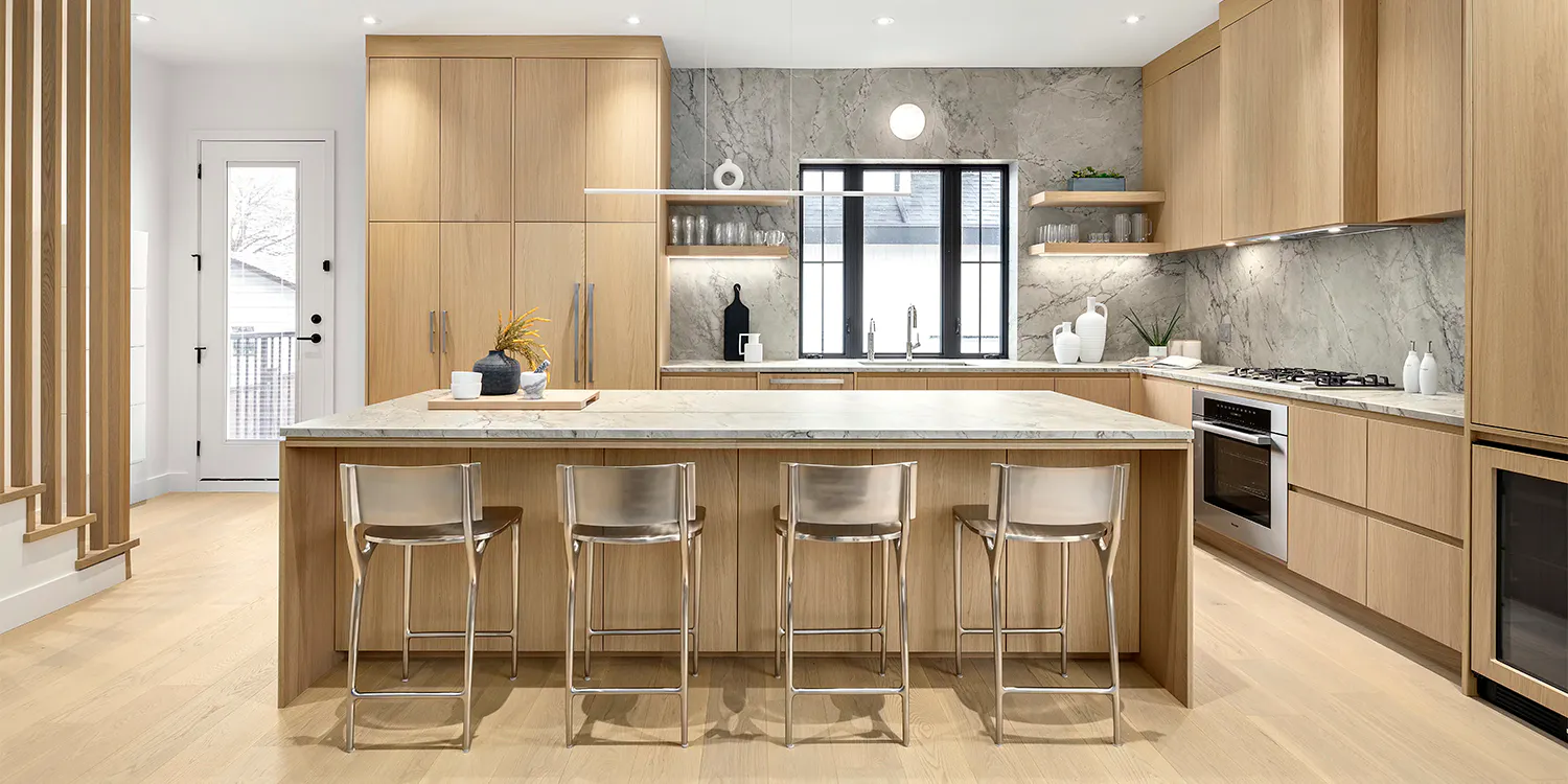 Modern kitchen with wood cabinets, large island, and bar seating.