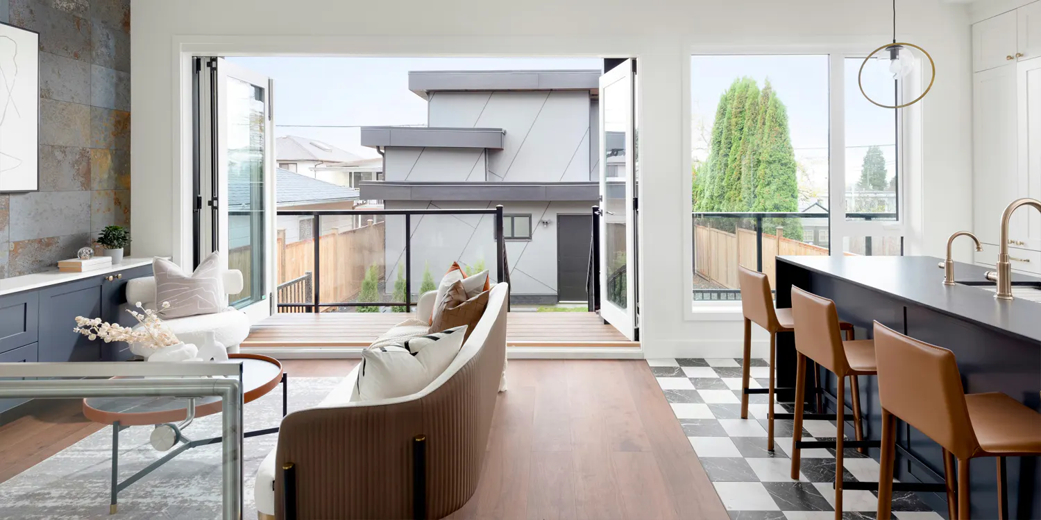 Open-concept living room and kitchen with patio doors and bar seating.
