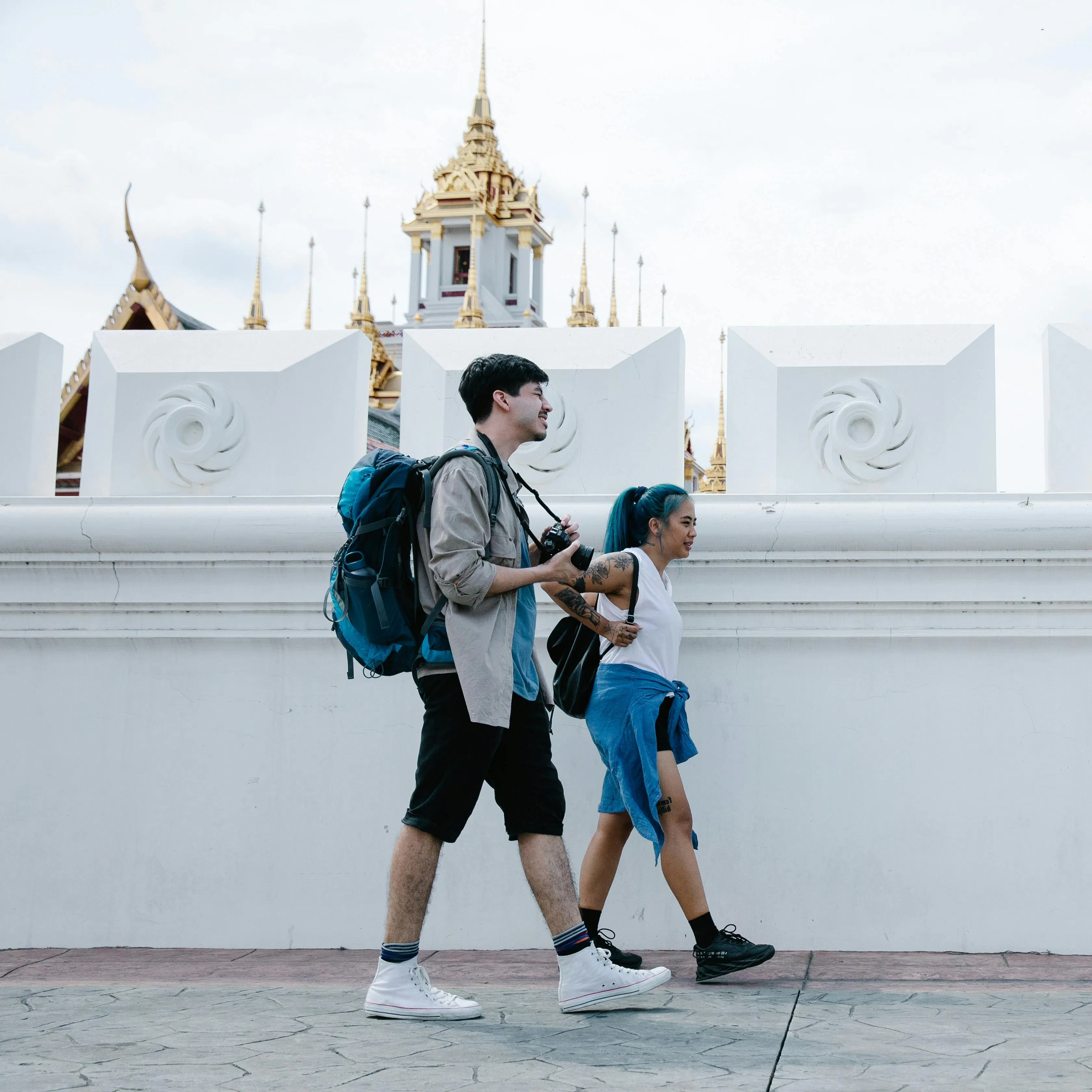 horizontal picture of 2 people walking with travel gear
