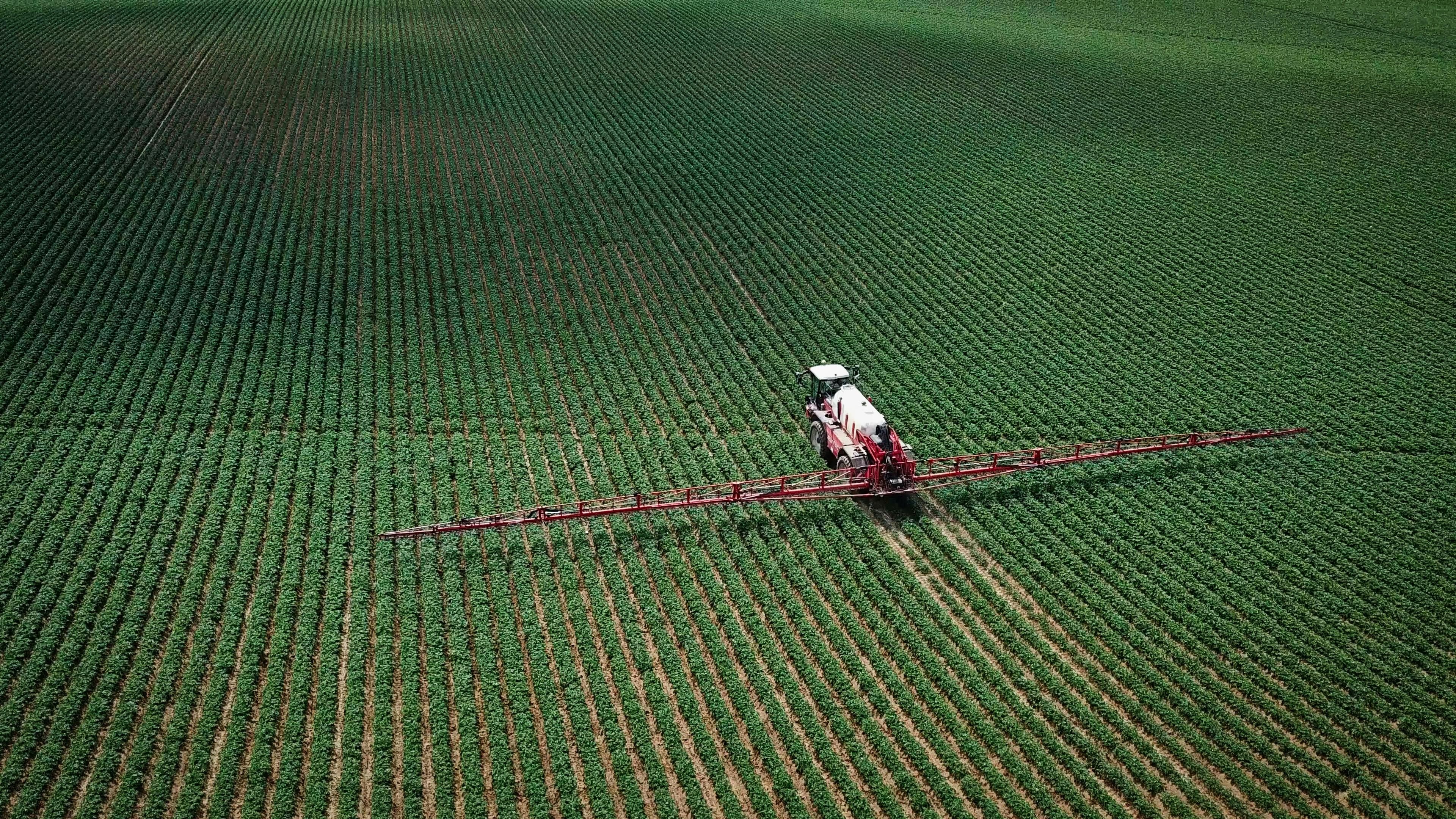 Spraying pesticides on agricultural land