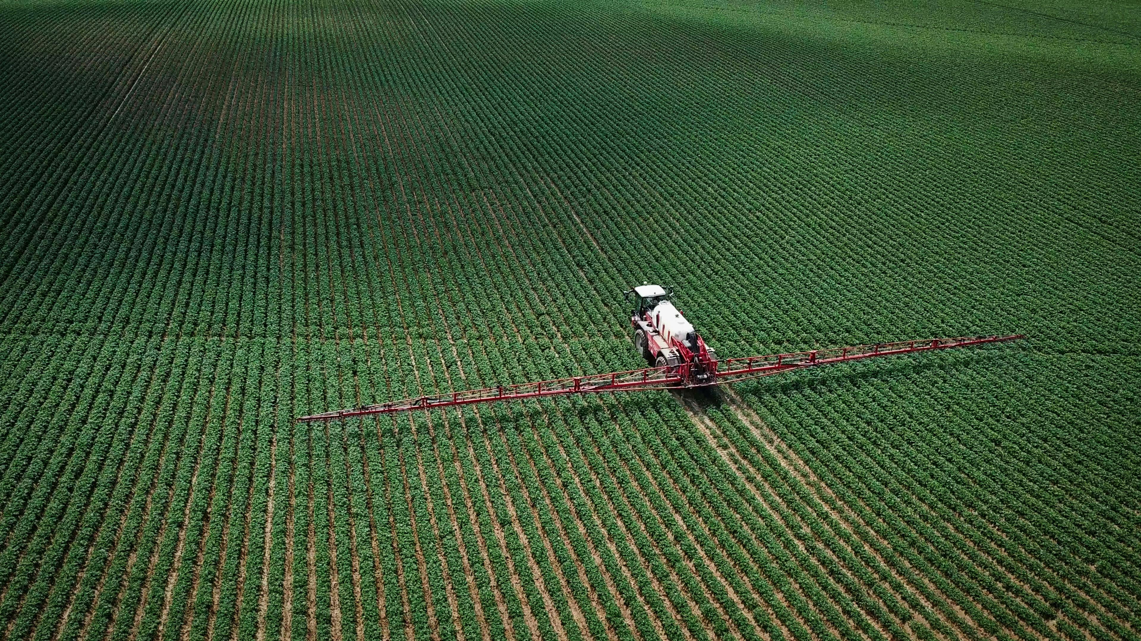 Spraying pesticides on agricultural land