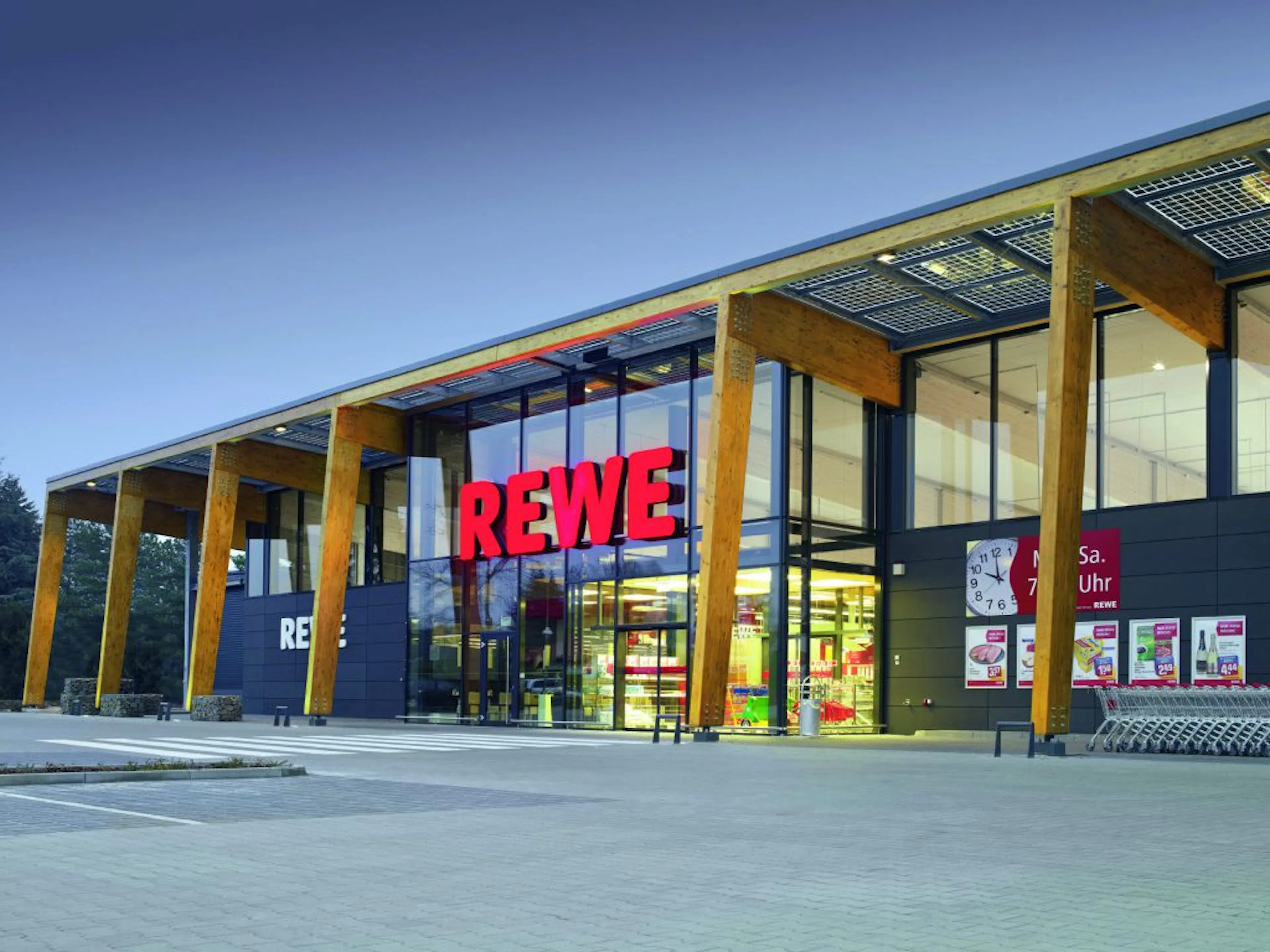 Exterior of a REWE supermarket building.