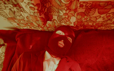 A red man lying on a bed