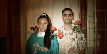 A girl and men wearing flowers