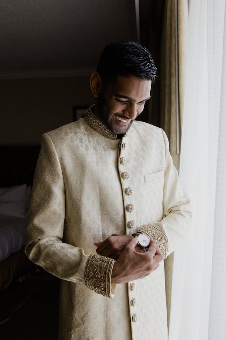 stylish groom poses before wedding