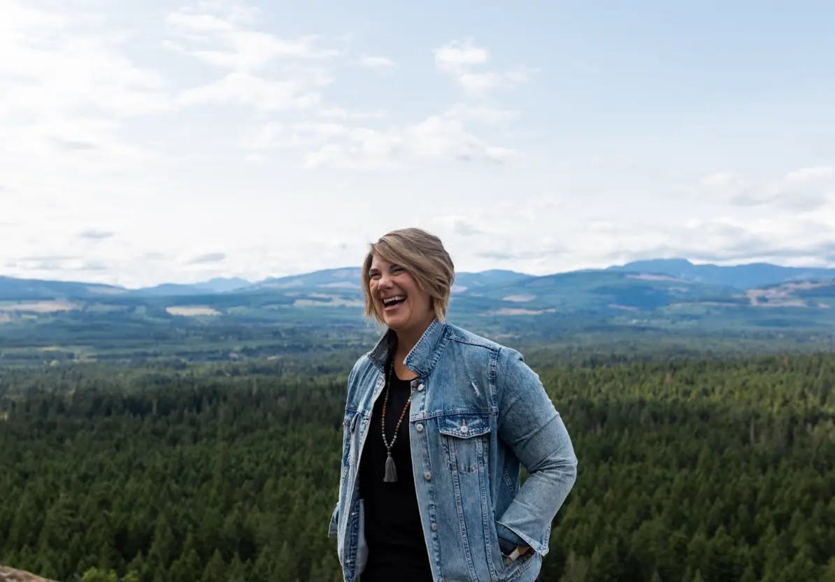 Gillian Goerzen smiling in front of a forest