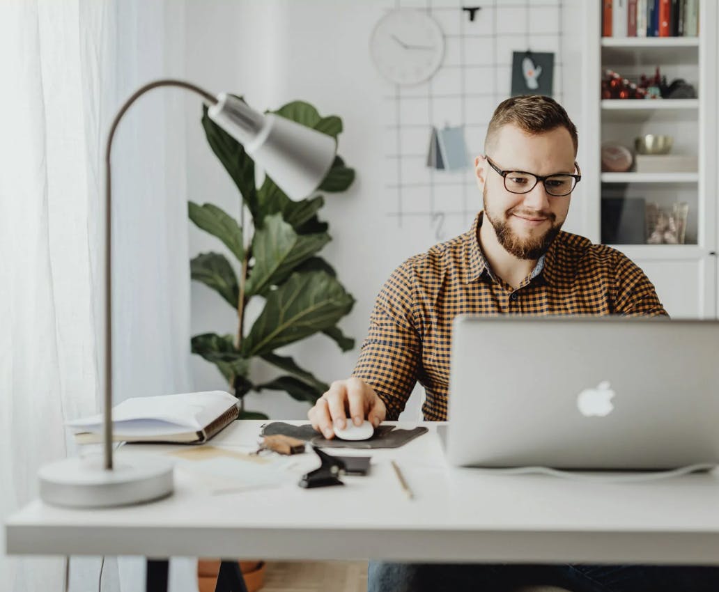Man with glasses sitting in front of laptop