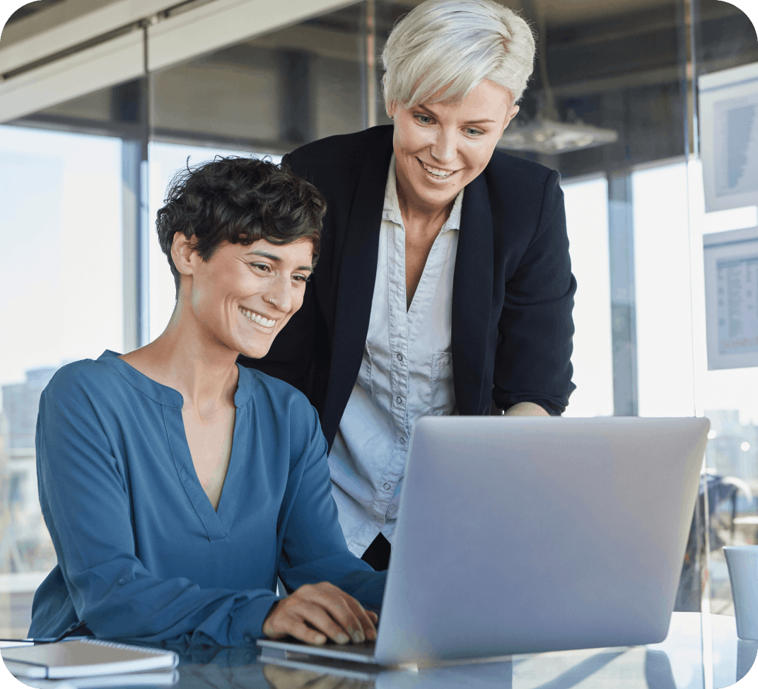 Two people working at a laptop