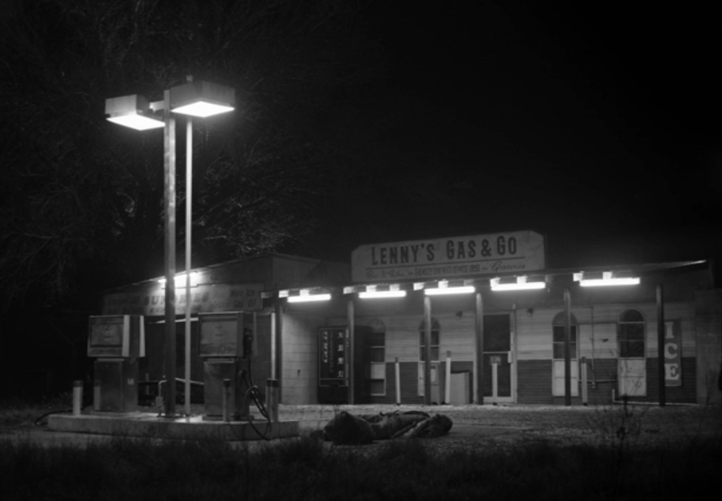 A black and white image of an old gas station