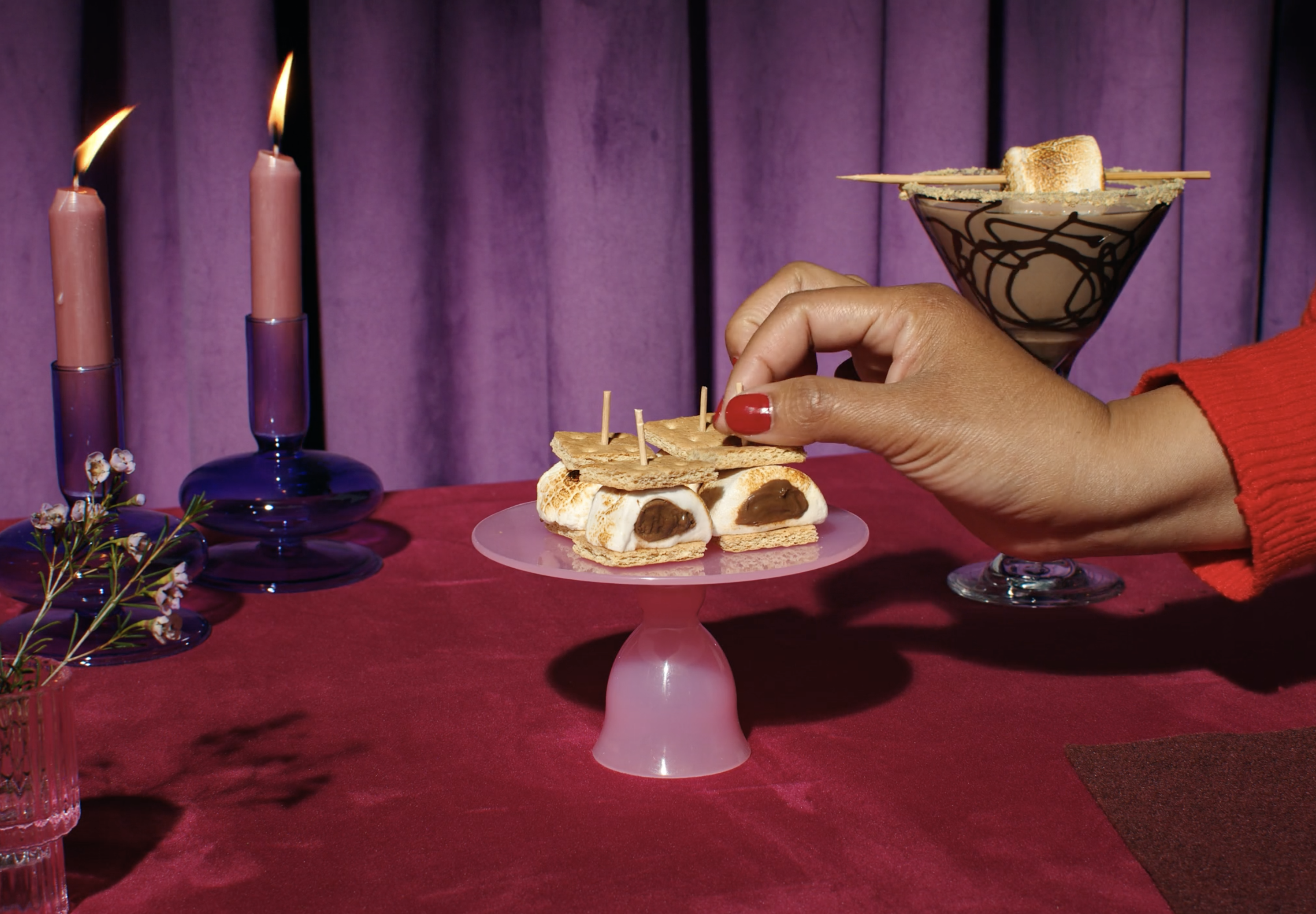 A cake plate of Stuffed Puff smores with a chocolate marshmallow martini in the background