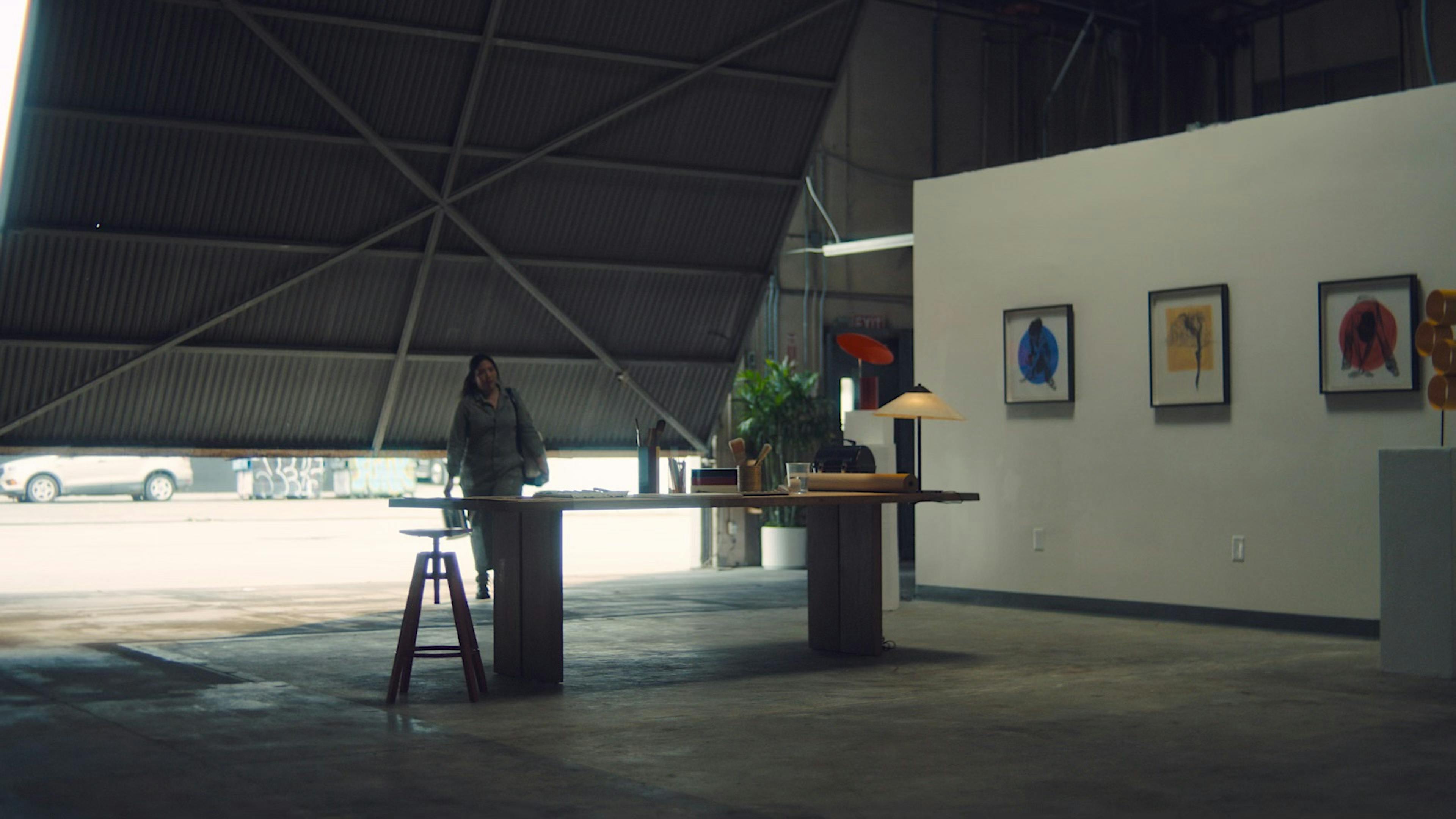 Artist walks into a garage/gallery space
