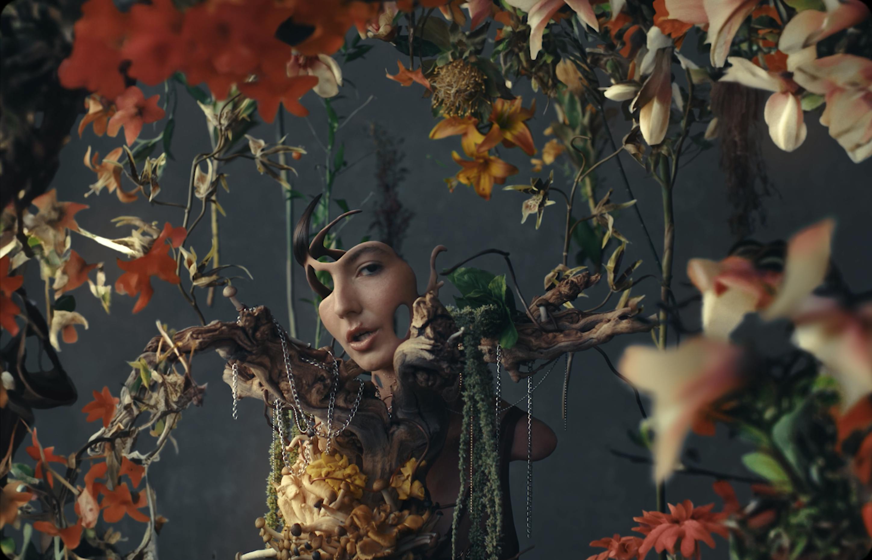 A woman with pieces of herself erased from her and flowers surrounding her