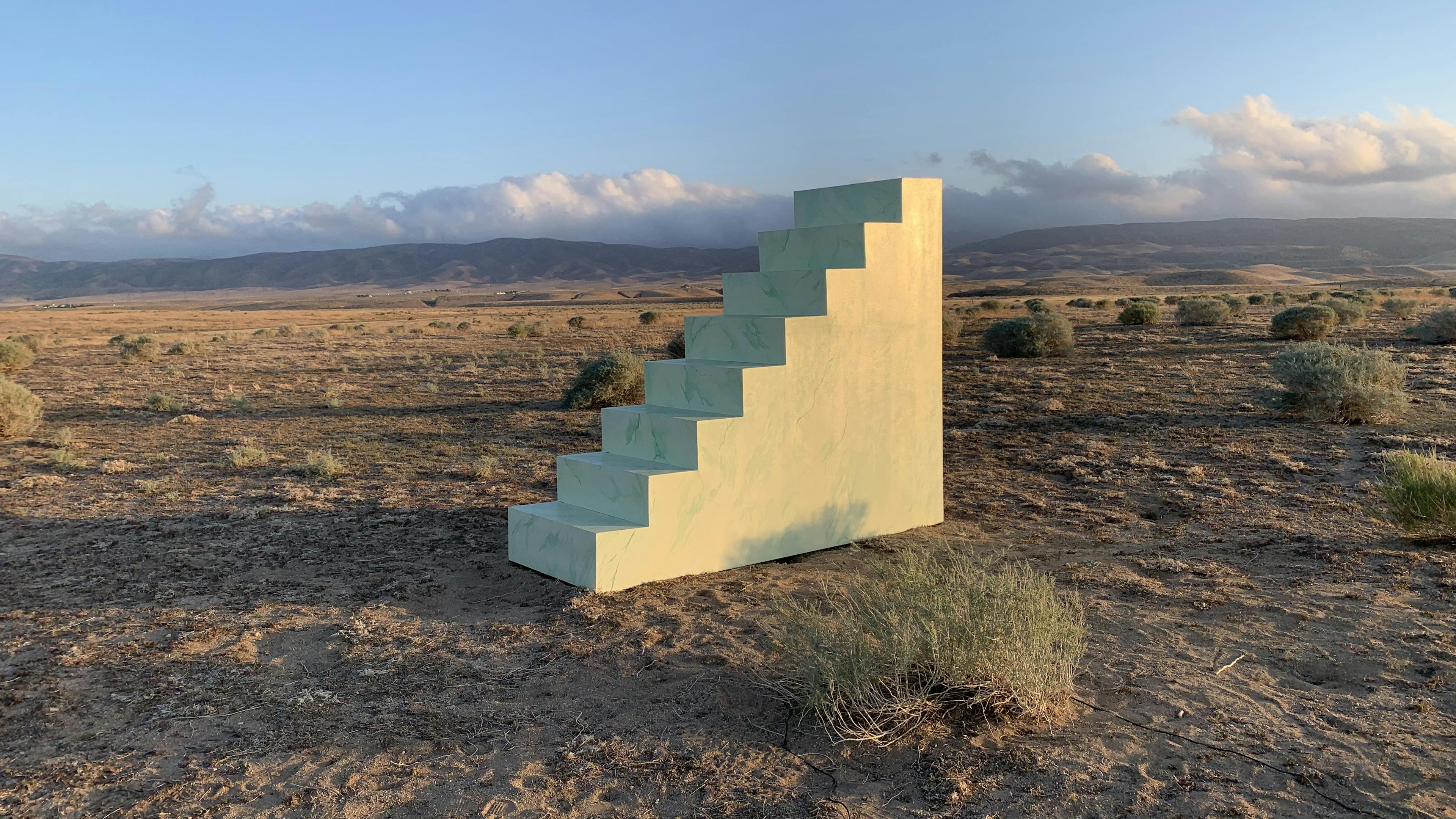 A concrete staircase sits in the desert