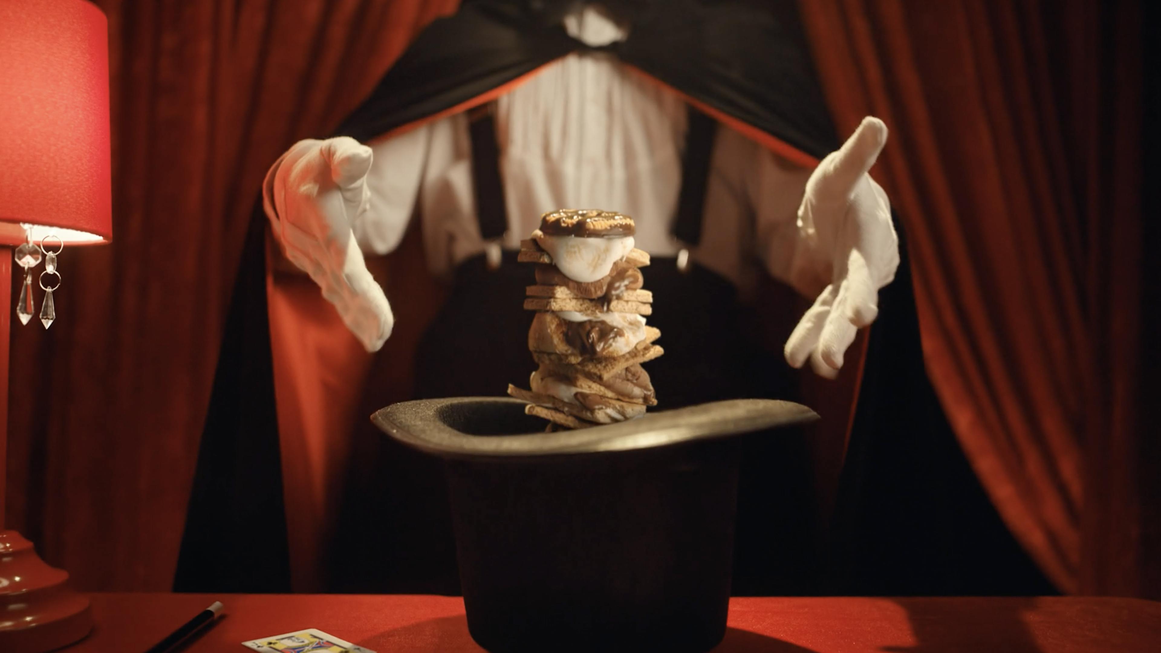 A magician pulls Stuffed Puffed smores out of a hat