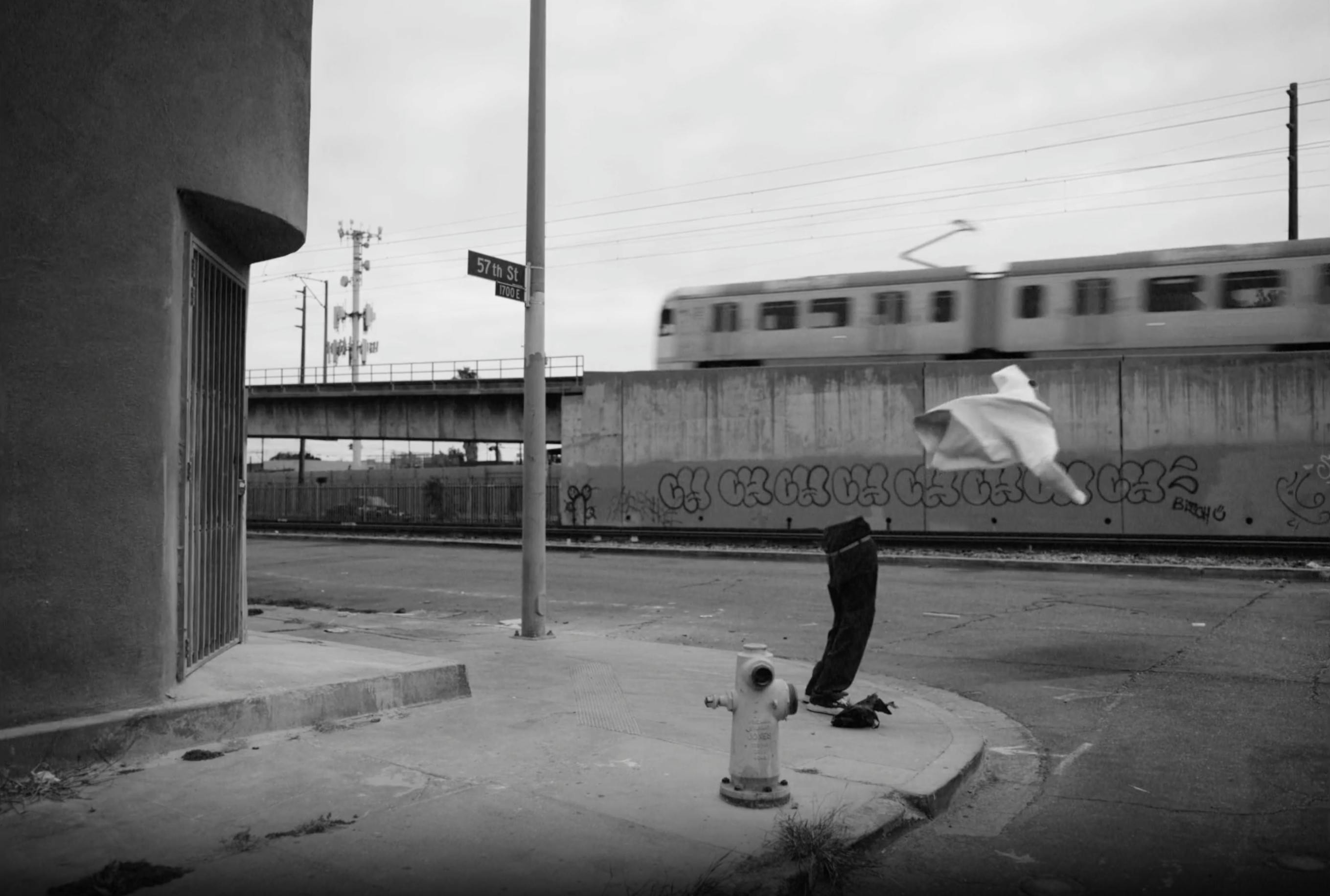A black and white image of a shirt flying off an invisible person