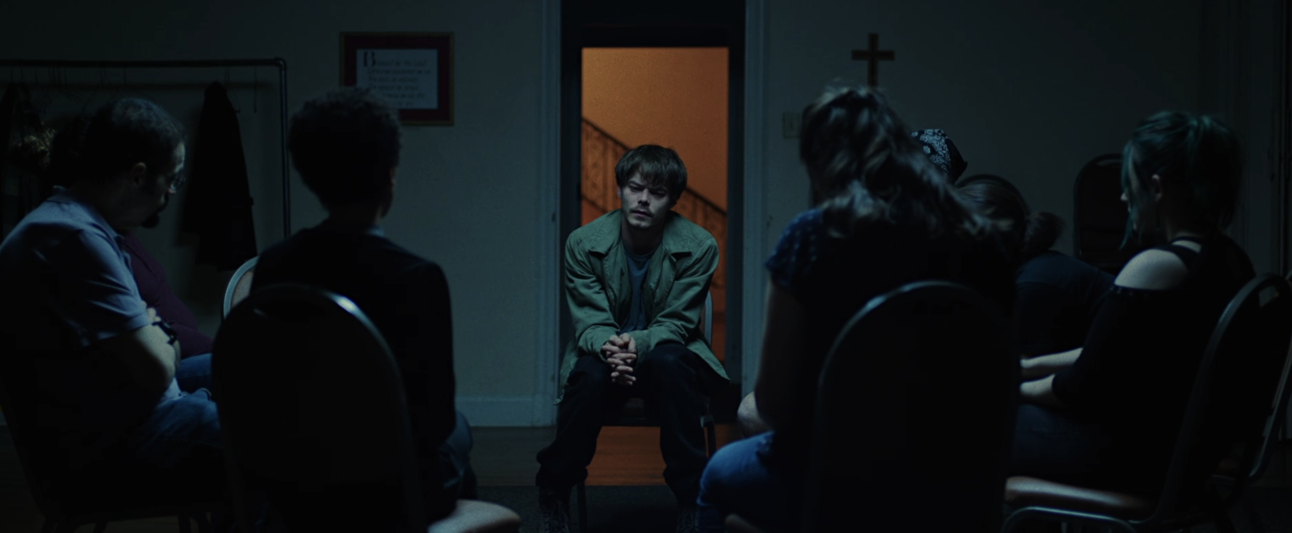 A man sits in a support group circle