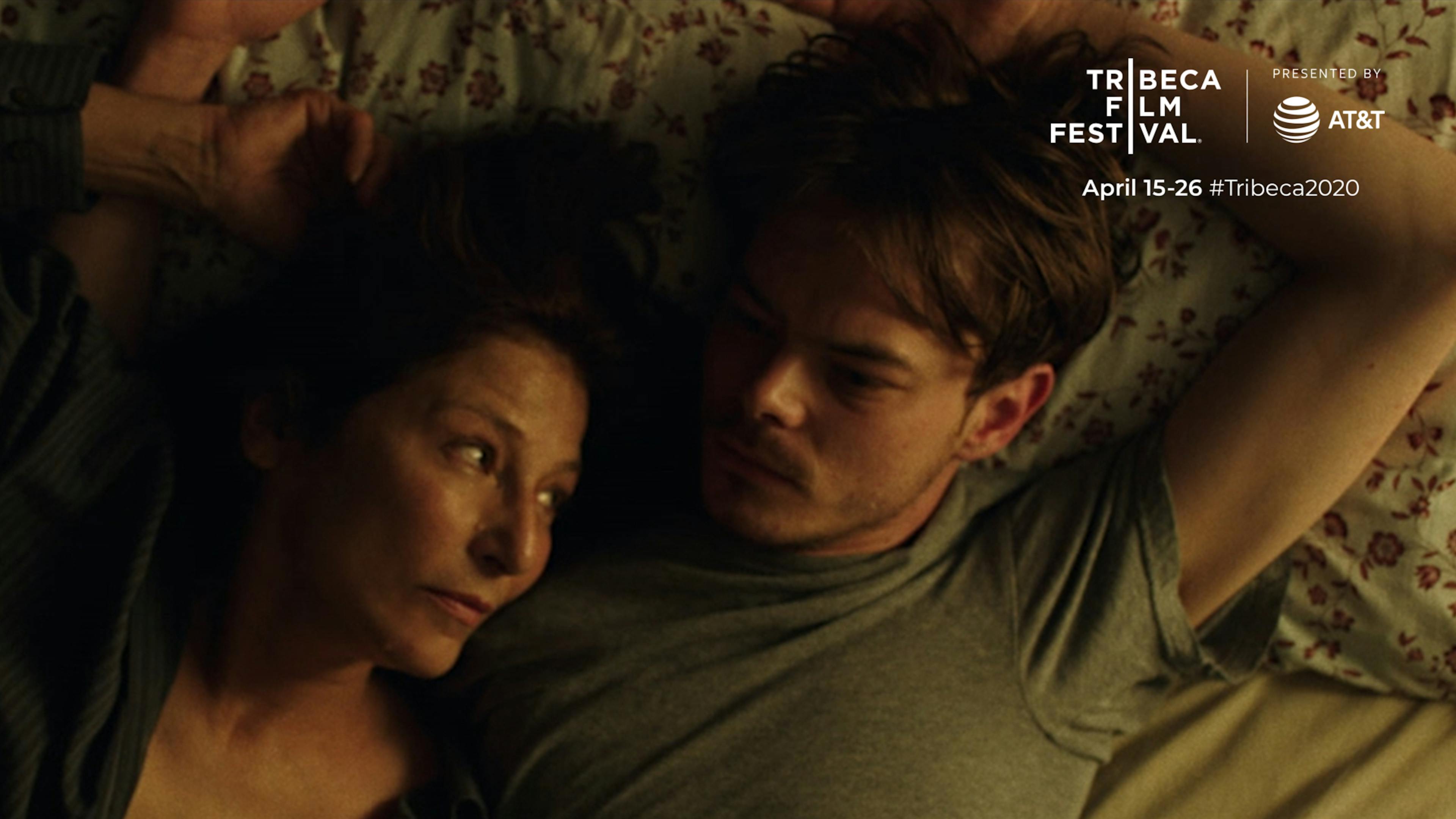 A man with an older woman lay on a bed together. Tribeca Film Festival 2020 text is shown in the upper right
