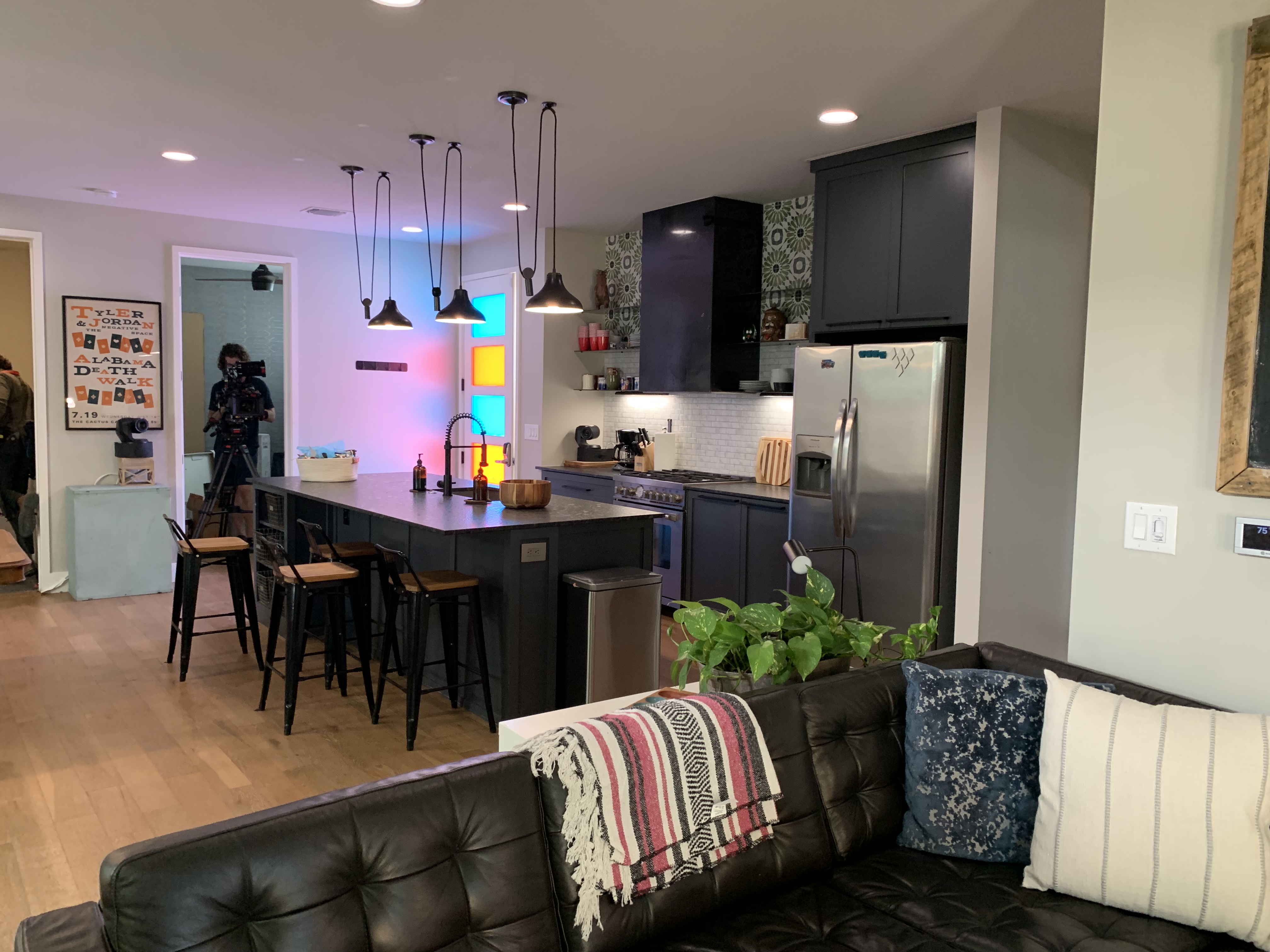A black kitchen counter with stool seating