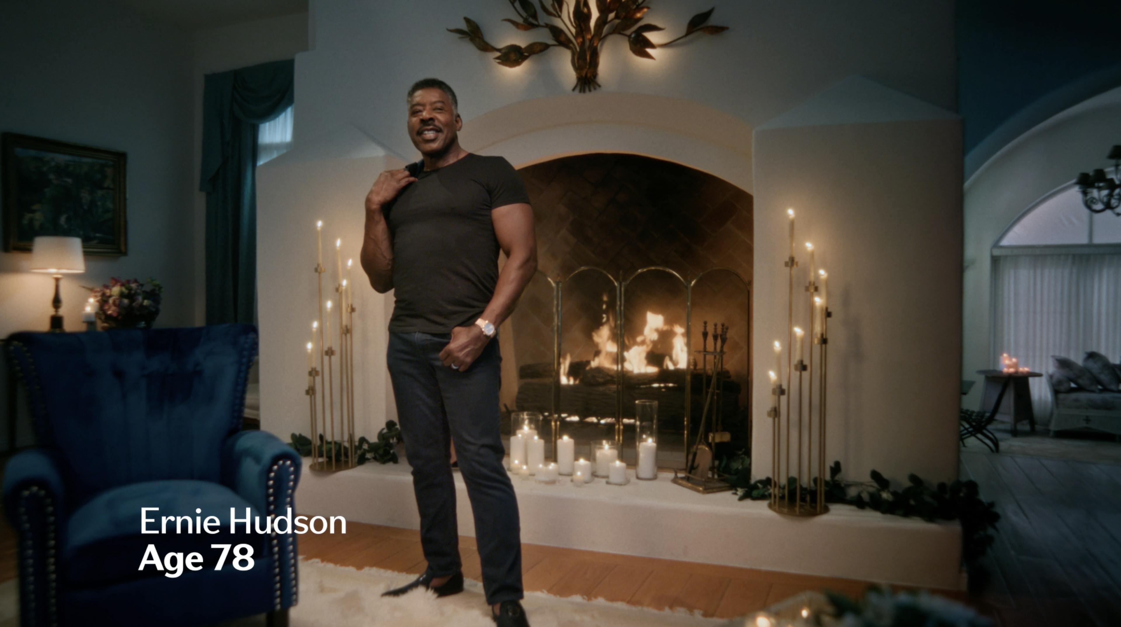 Ernie Hudson standing by fireplace