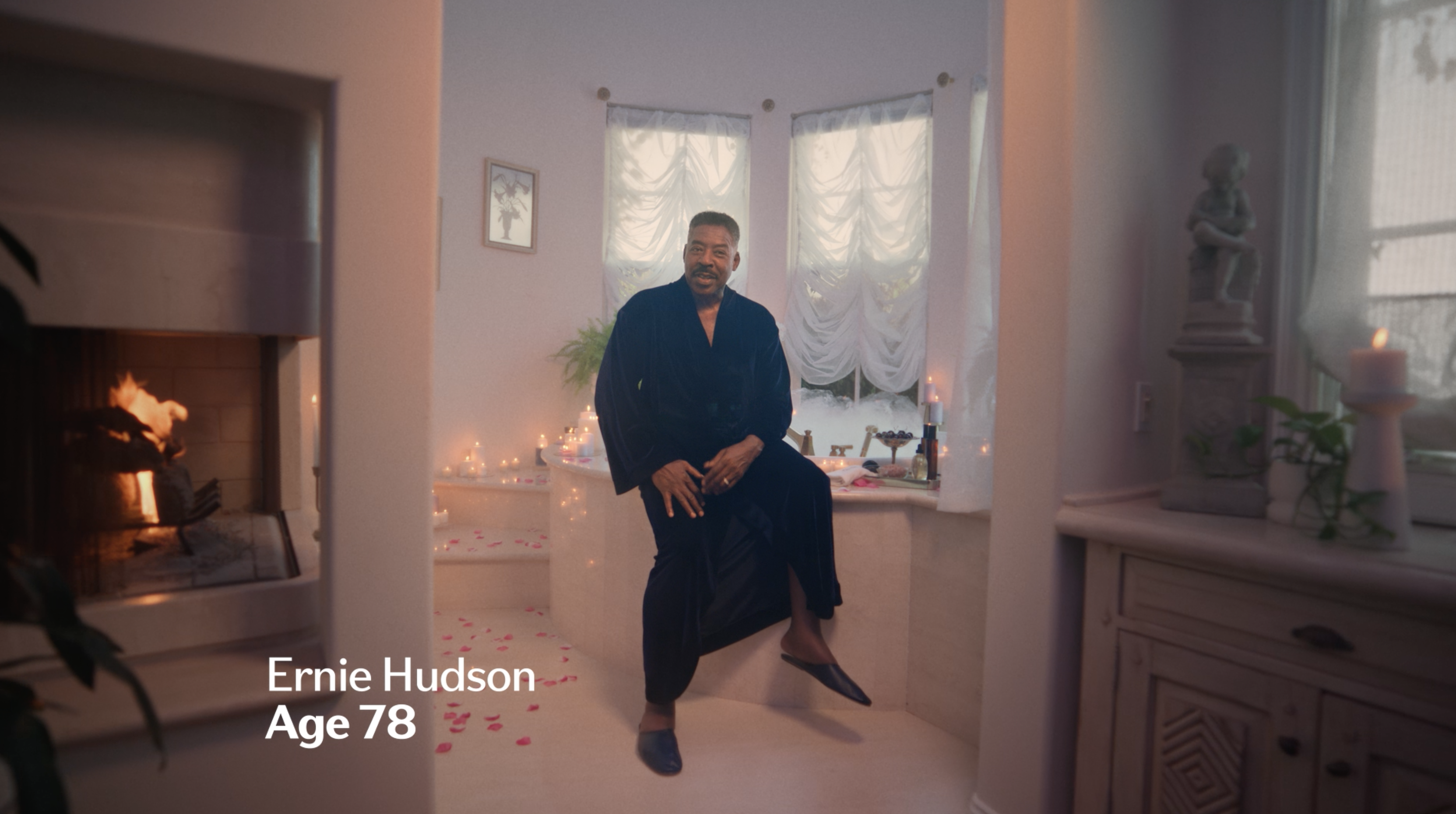 Earnie Hudson in a robe on edge of a bathtub
