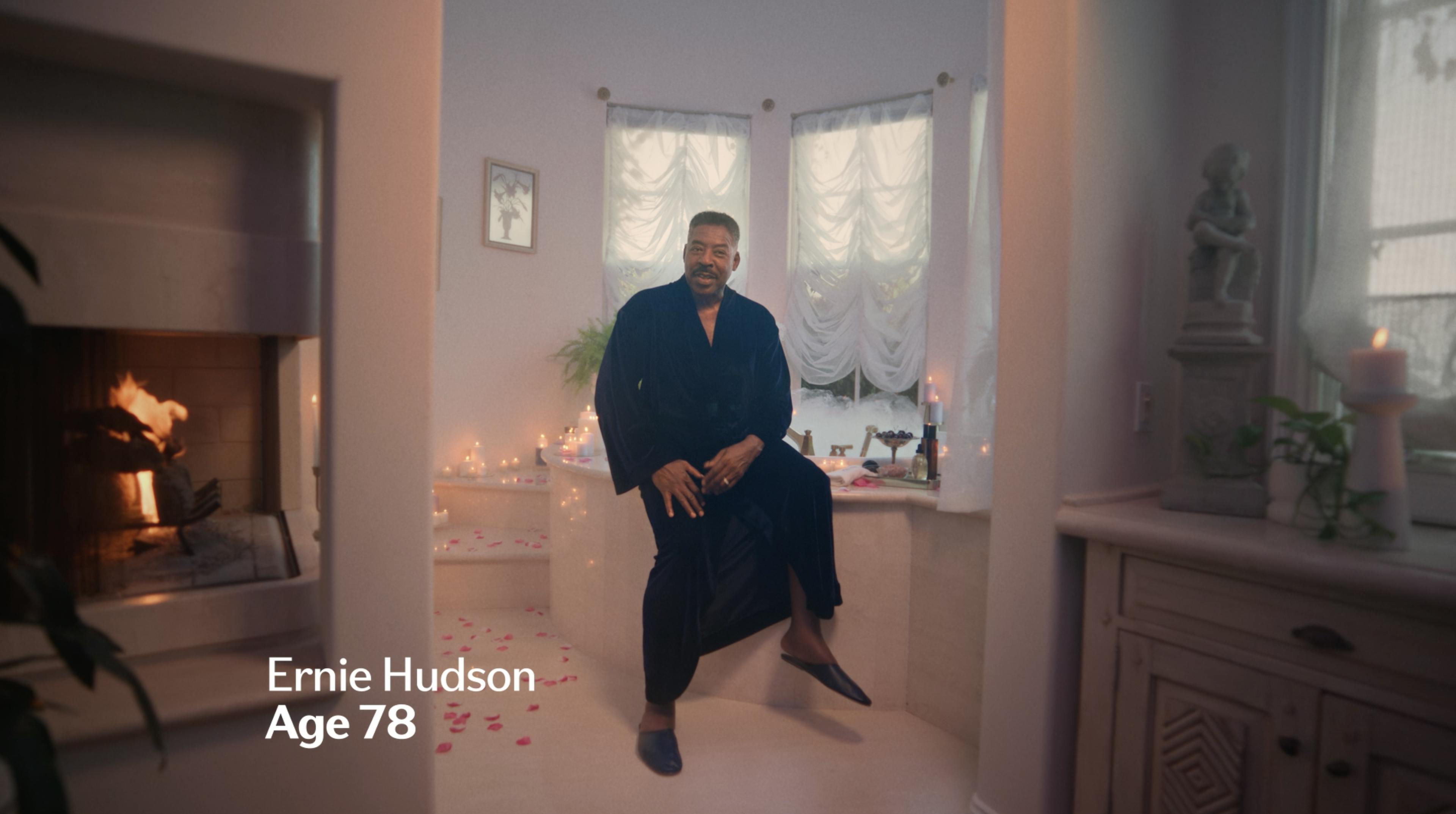 Earnie Hudson in a robe on edge of a bathtub