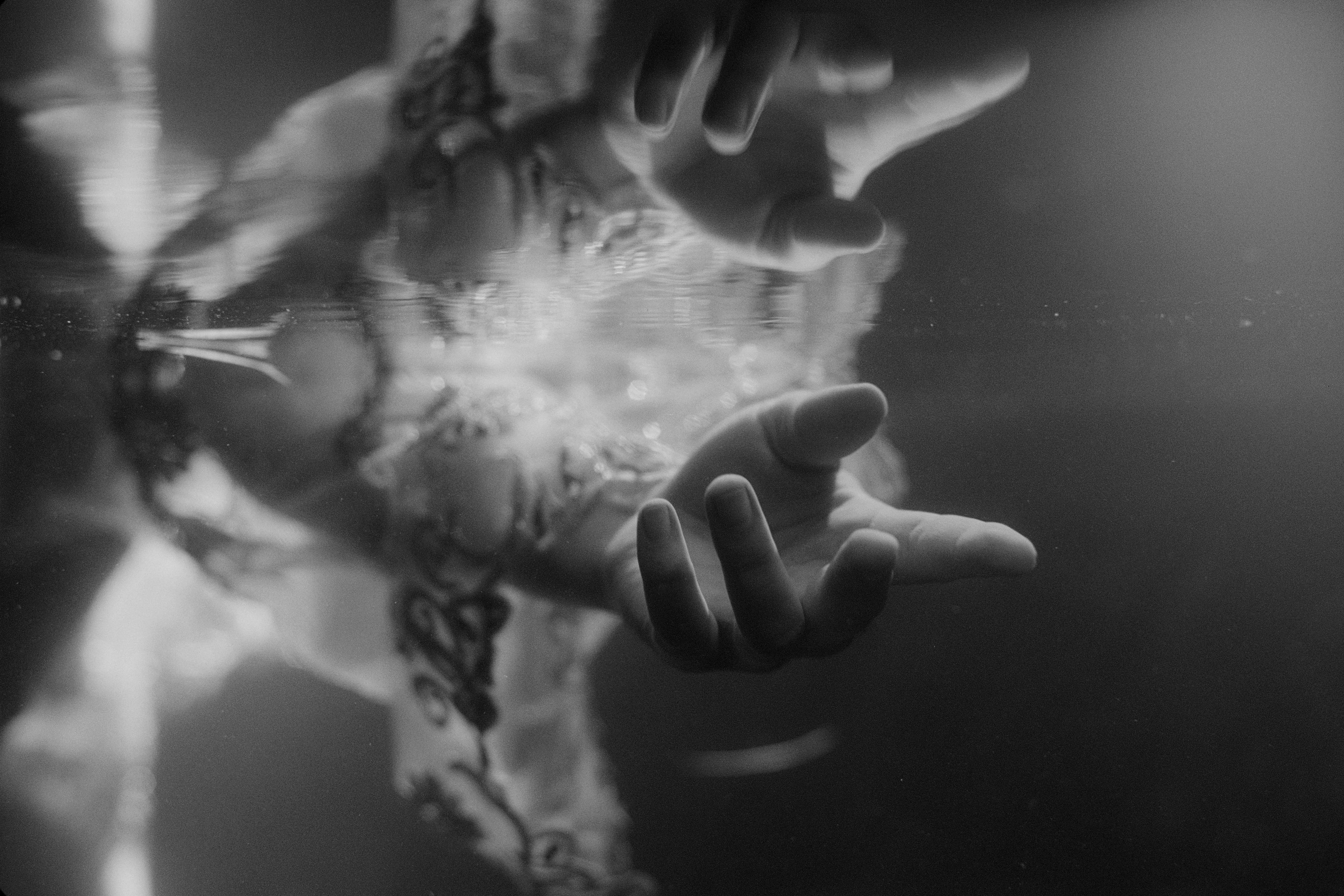 reflection of Mitski's hand over the surface of the water