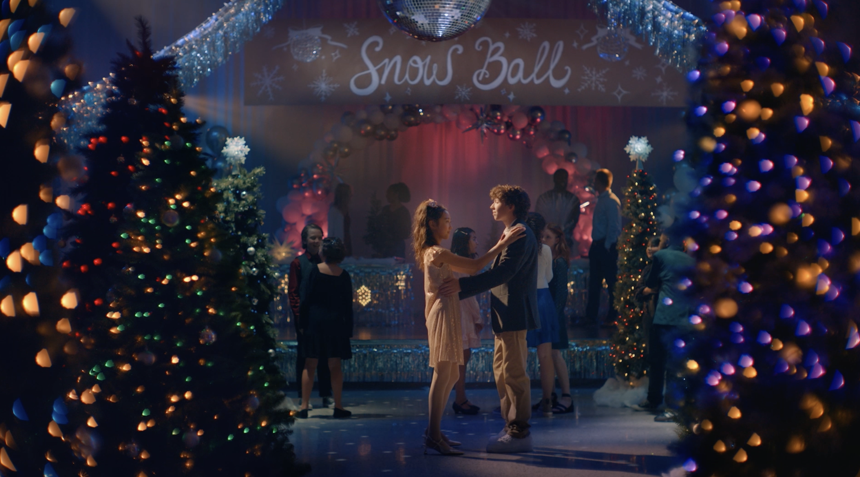 two teens at a holiday school dance