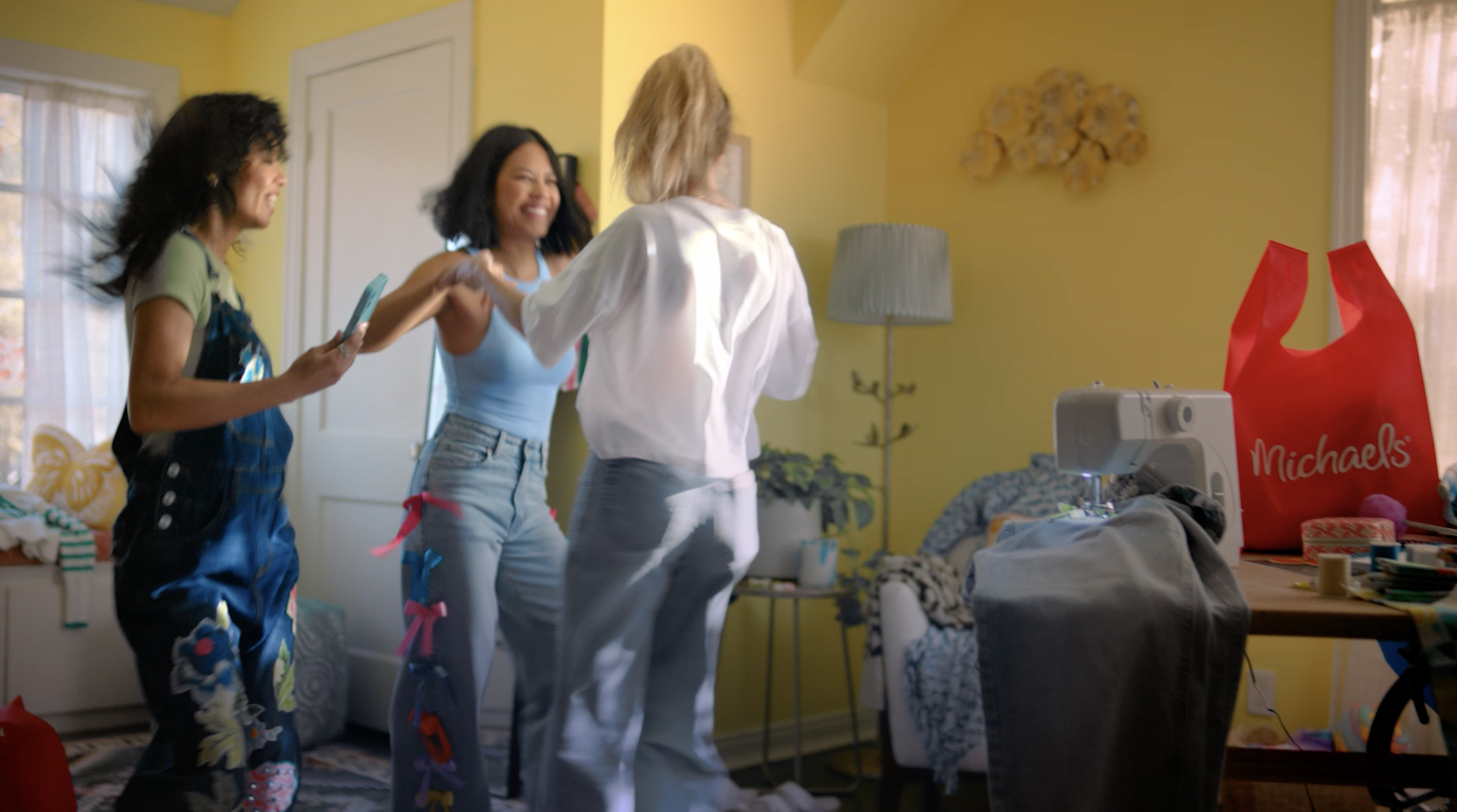 girls dancing in a yellow room