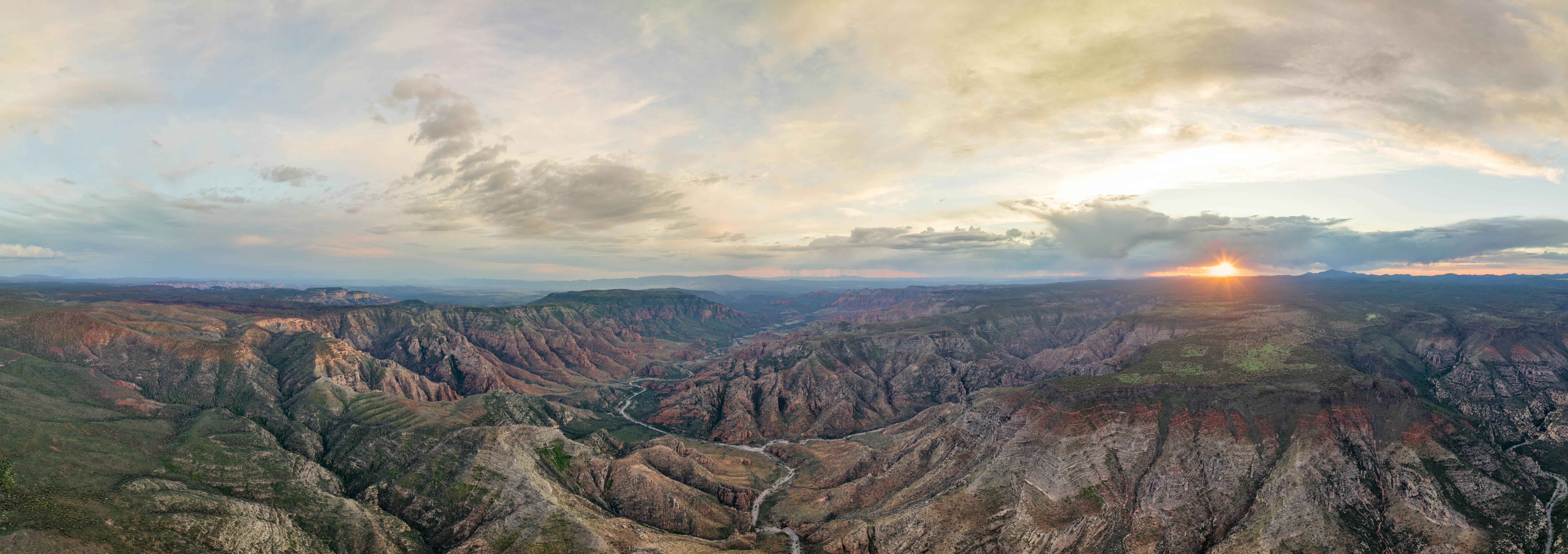 A panoramic photo of mountain ranges in Kaibab National forest by Jeff Poe