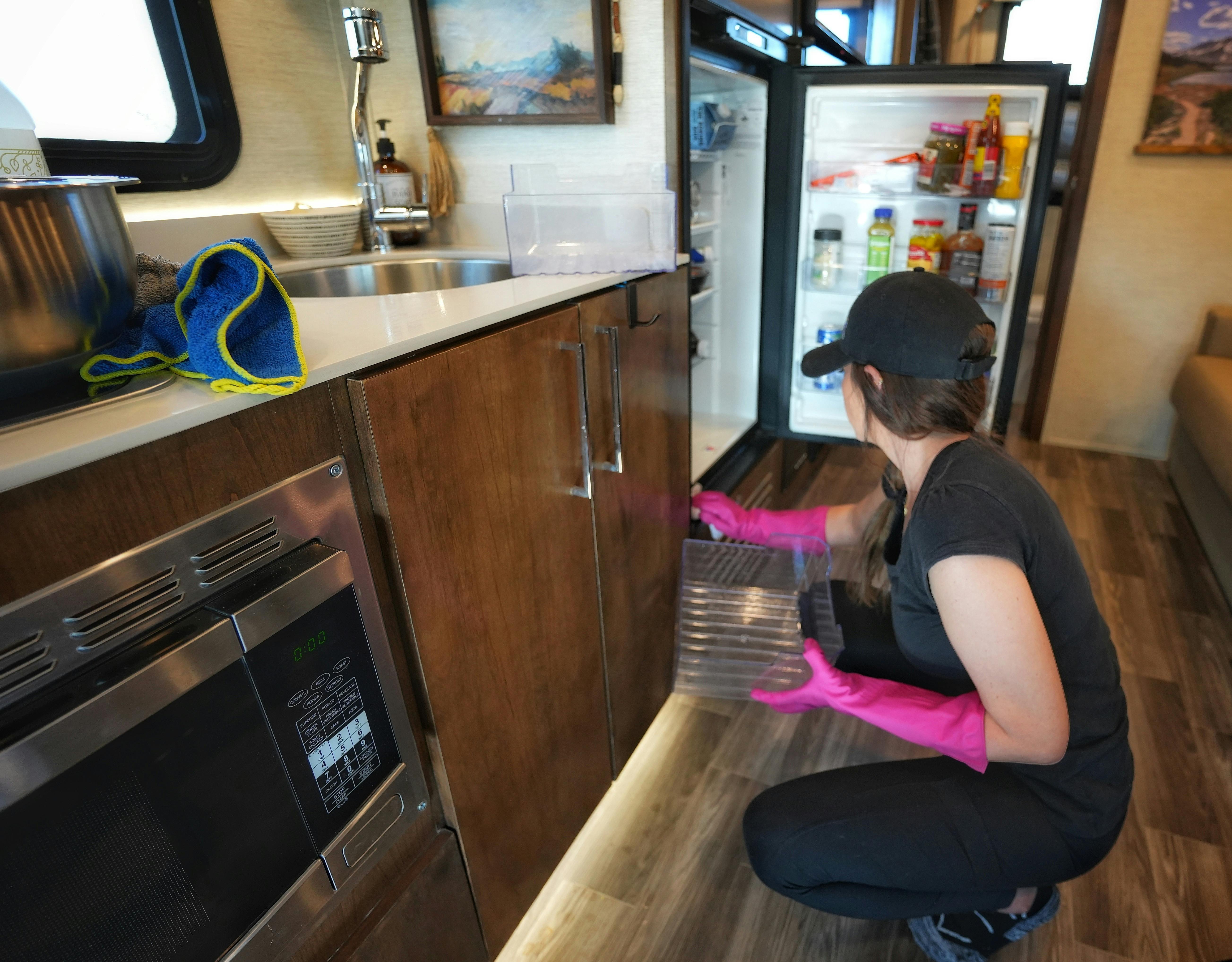 Sarah Bauer cleaning out the fridge in her RV
