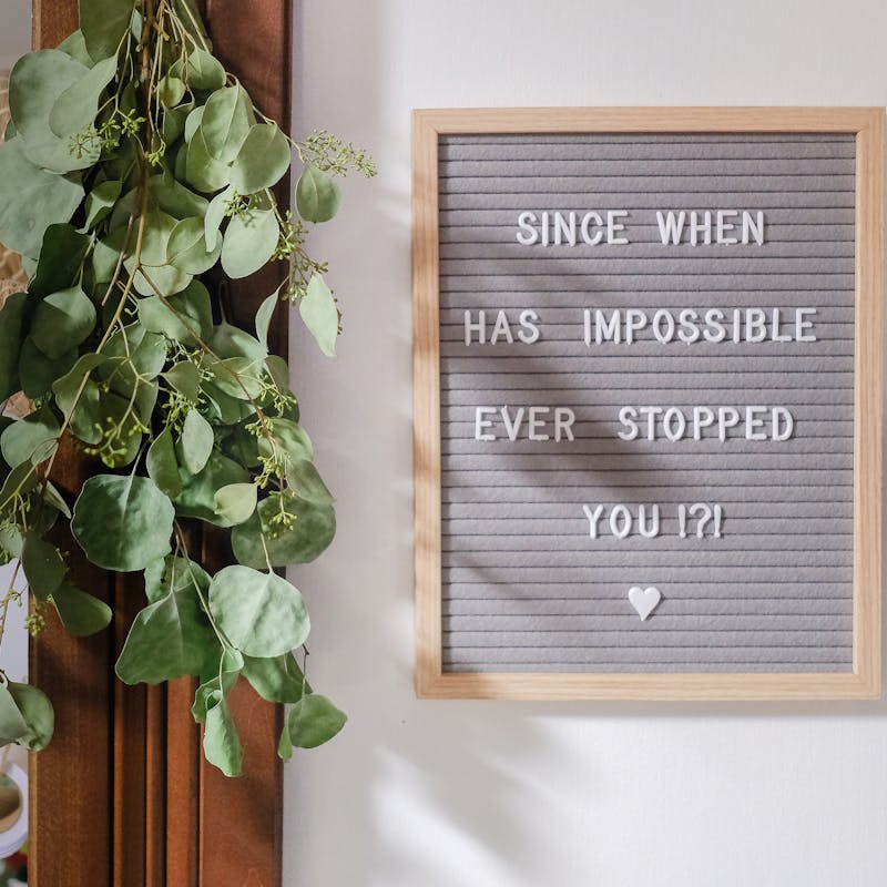 A sign reading "Since when has impossible ever stopped you?"