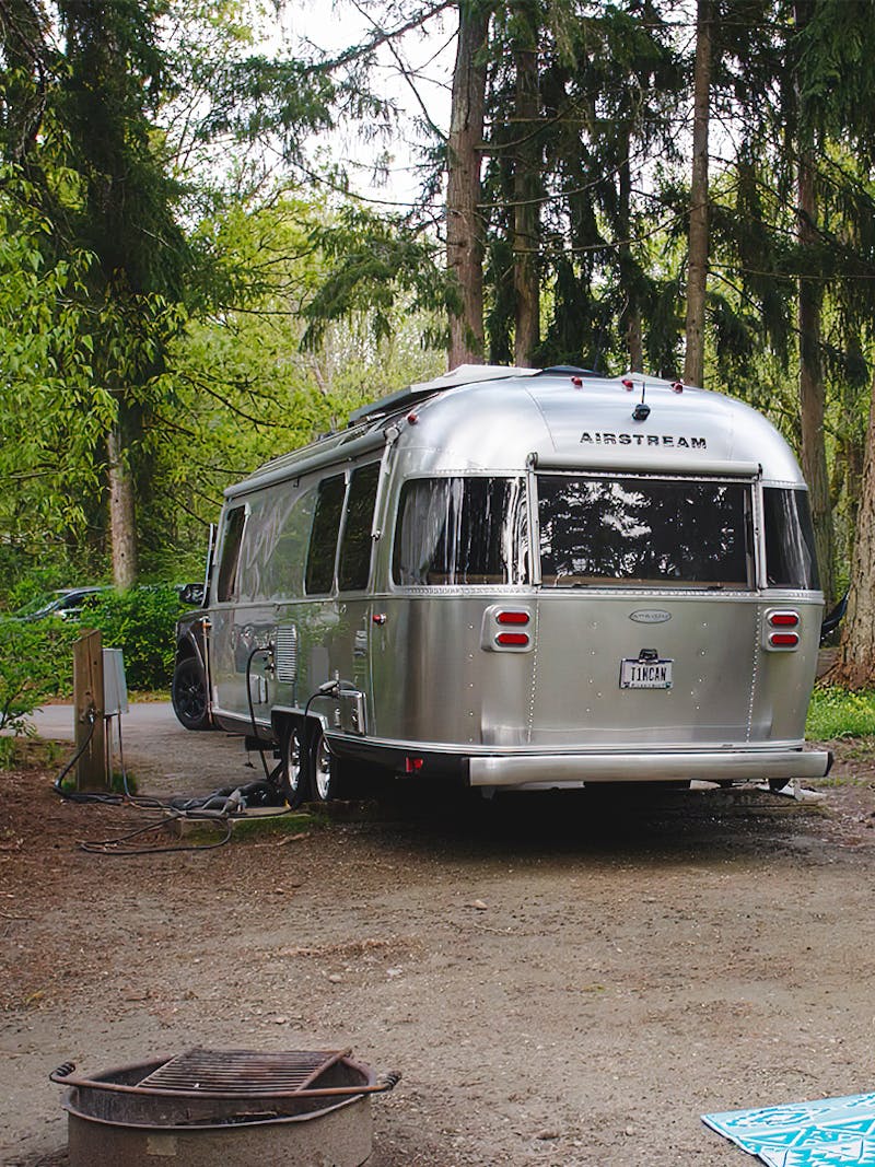 Stacey Powers Airstream Trailer parked at a campsite